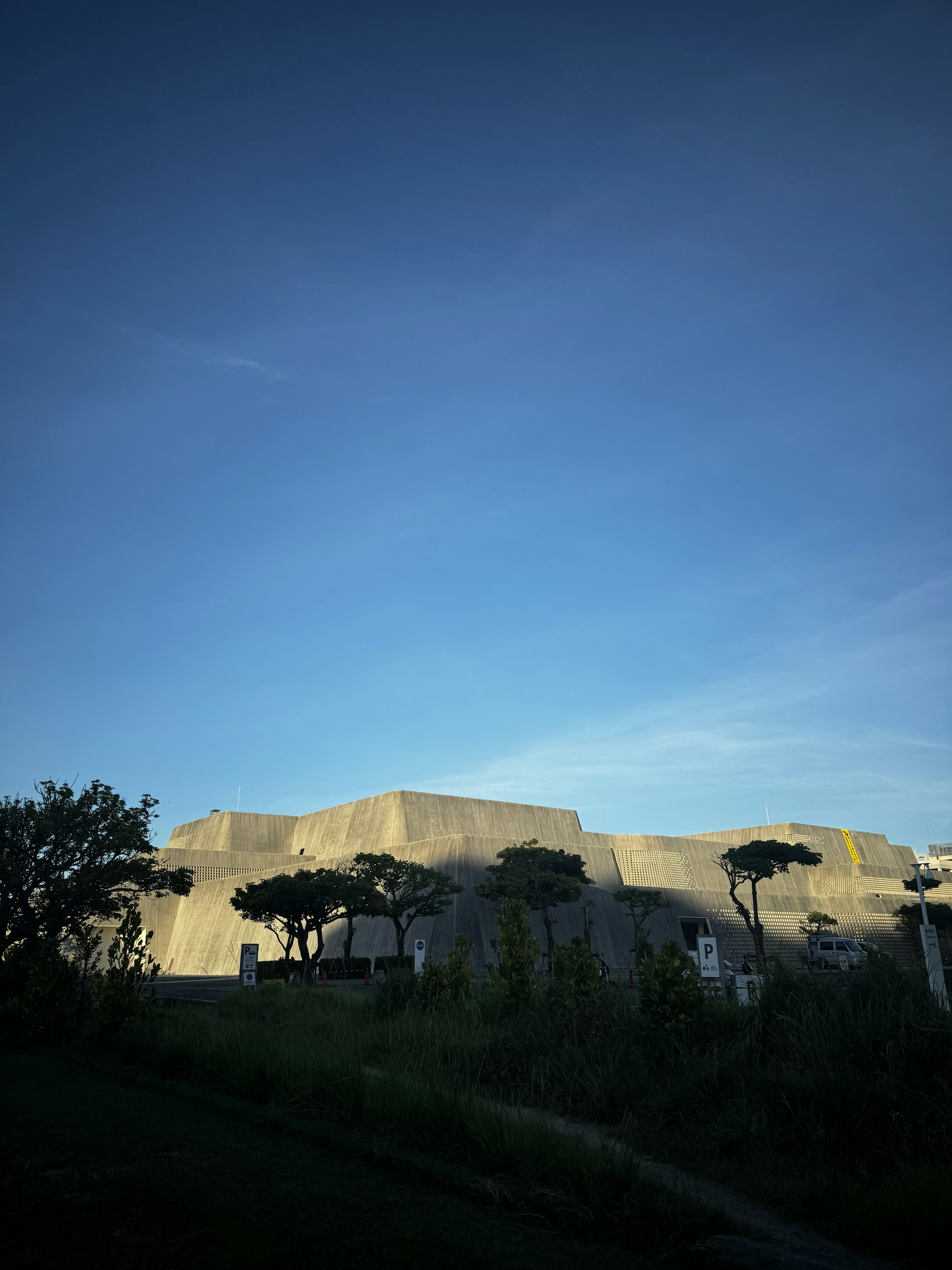 Modernes Gebäude unter einem blauen Himmel mit grünen Bäumen