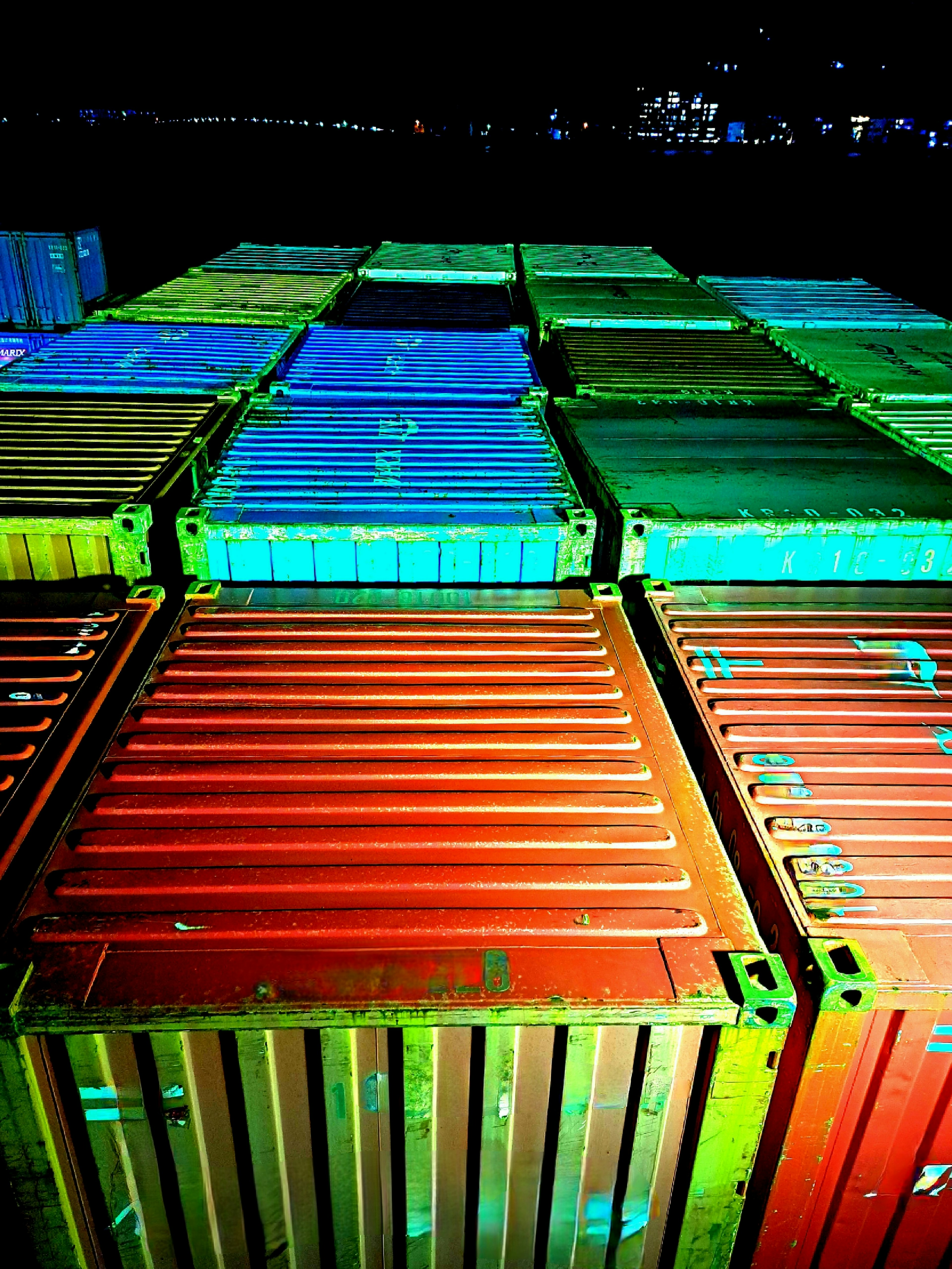 Colorful shipping containers arranged in a night port setting