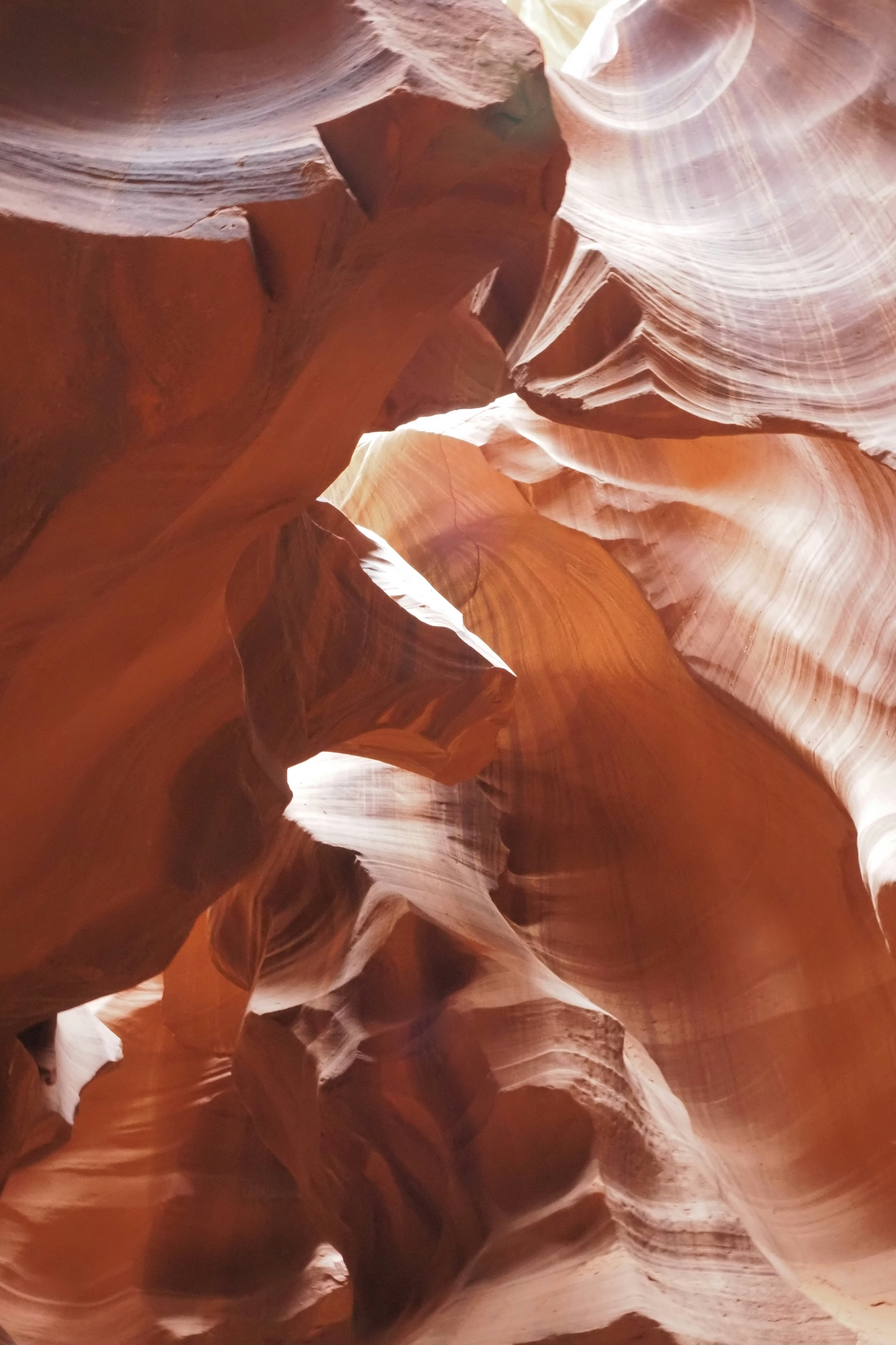 Antelope Canyon with flowing patterns in reddish-brown rock