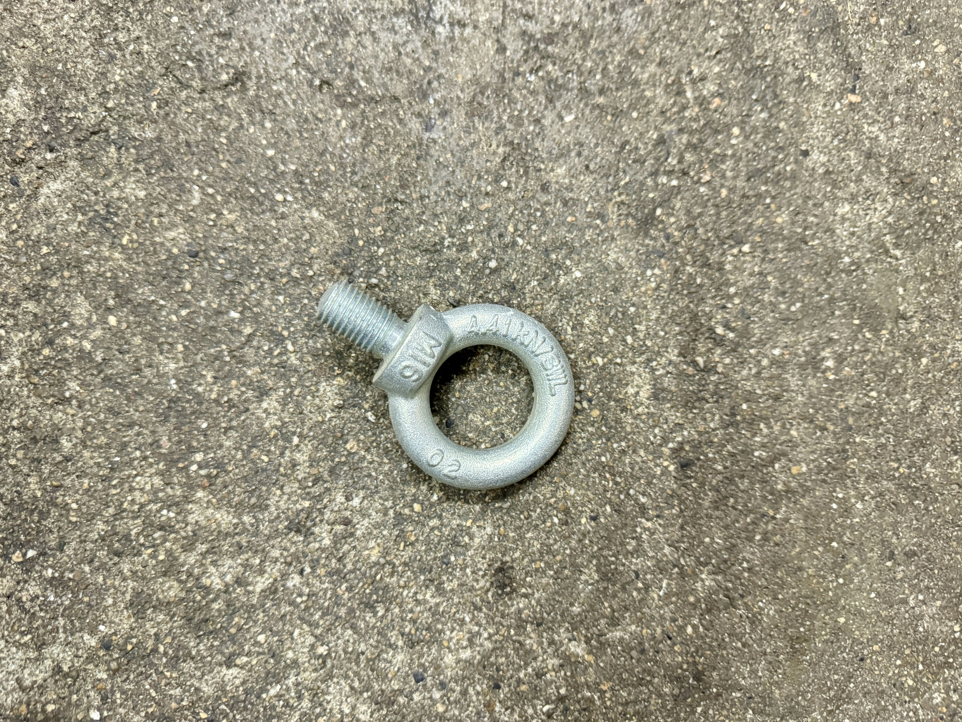 Gray metal ring resting on a concrete surface