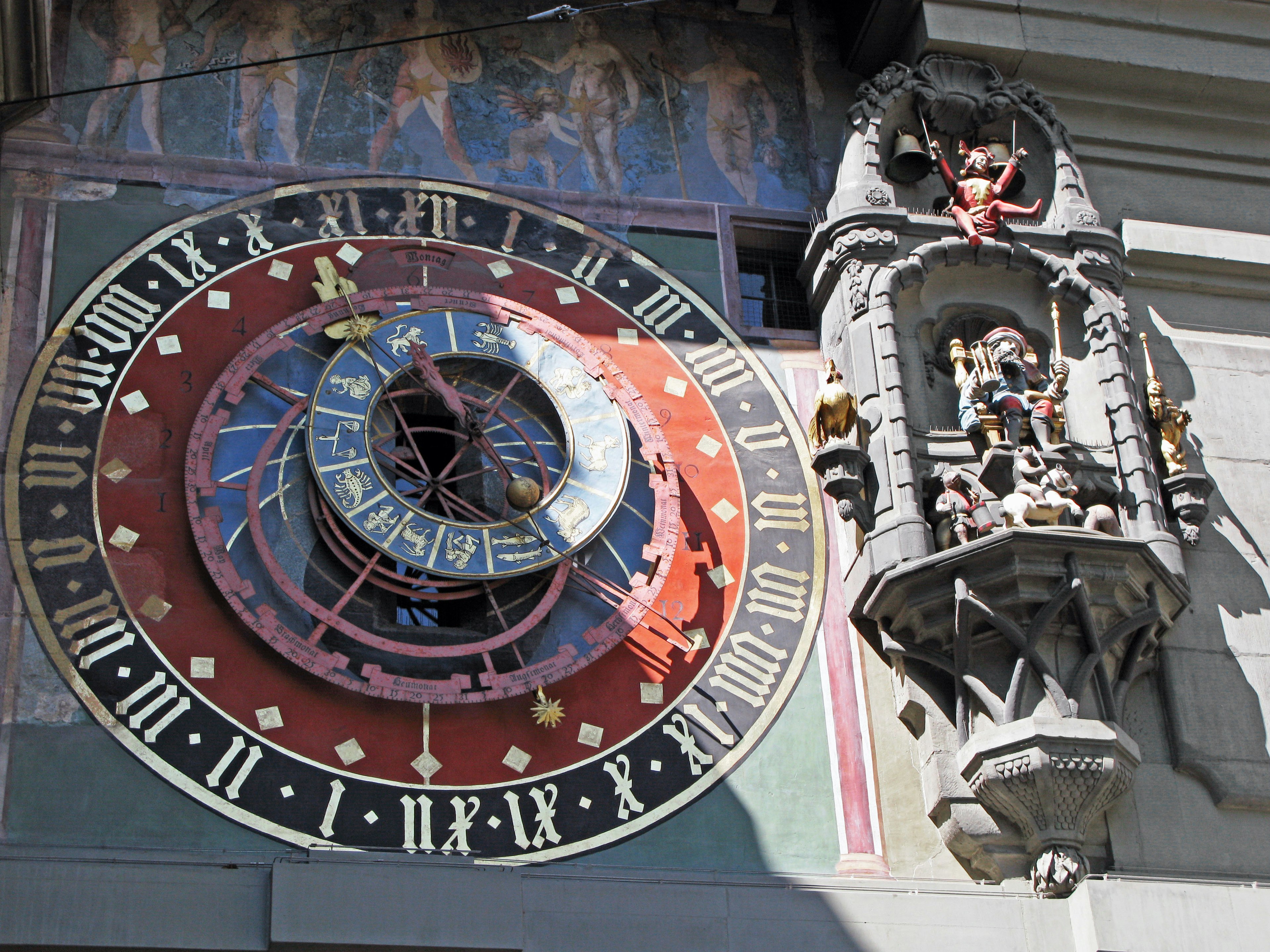 Historical building exterior featuring a beautiful clock and intricate sculptures