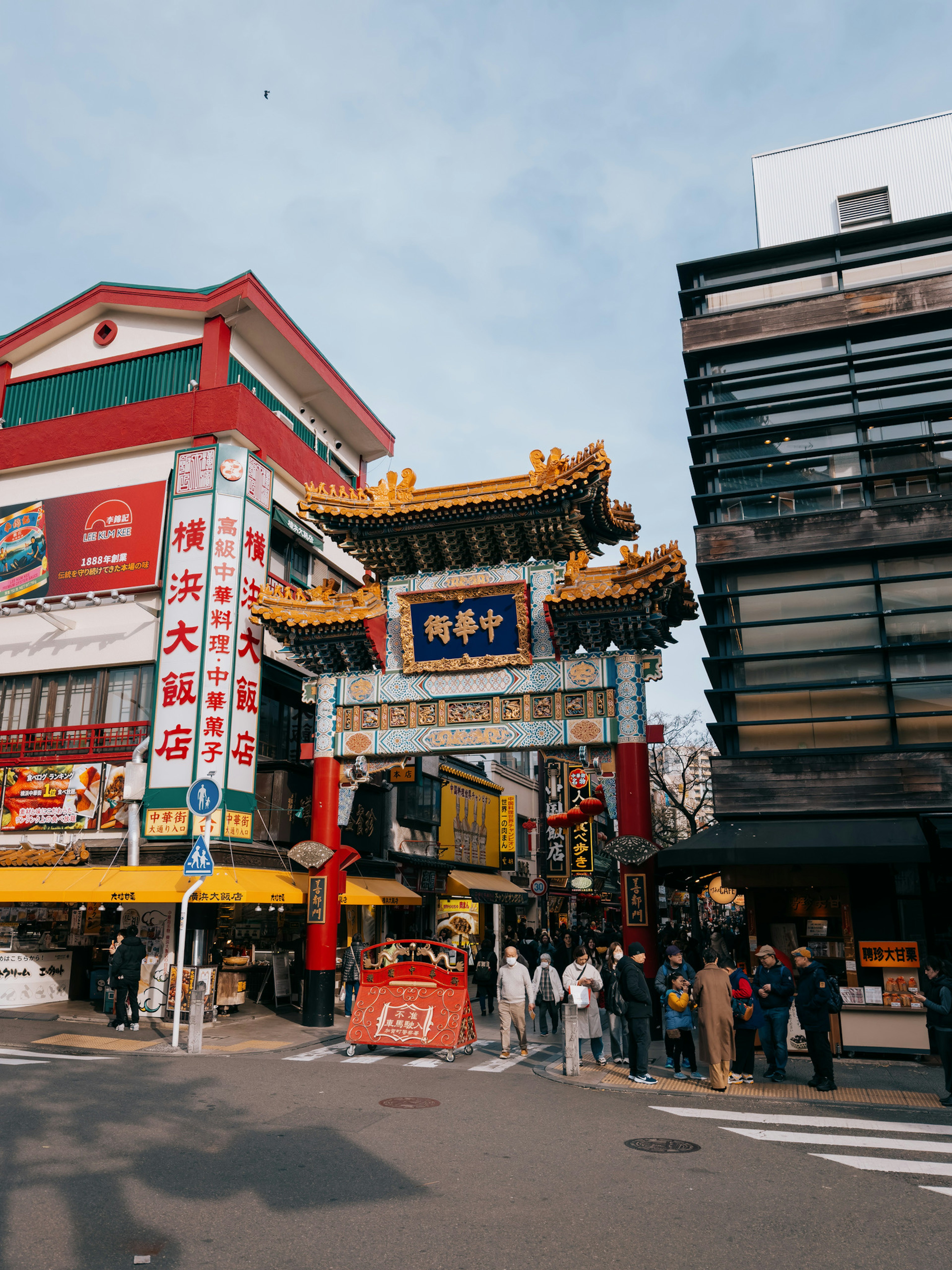 Vibrant entrance gate of Yokohama Chinatown with bustling street scene