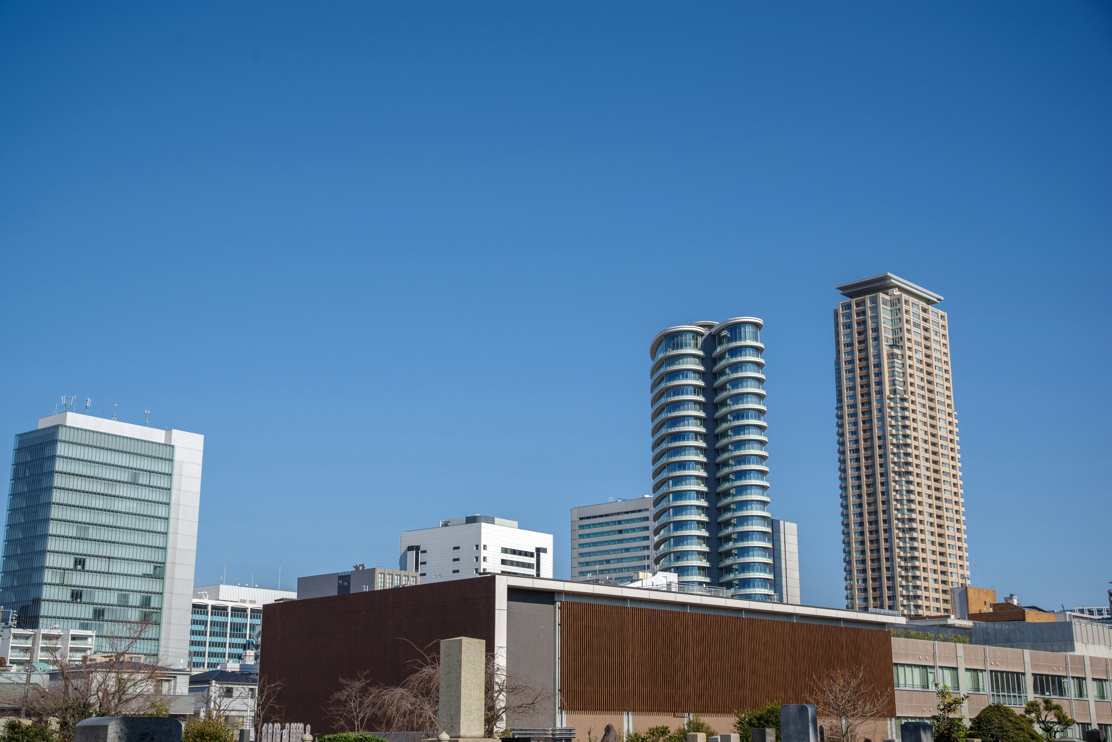 City skyline featuring modern skyscrapers and a clear blue sky