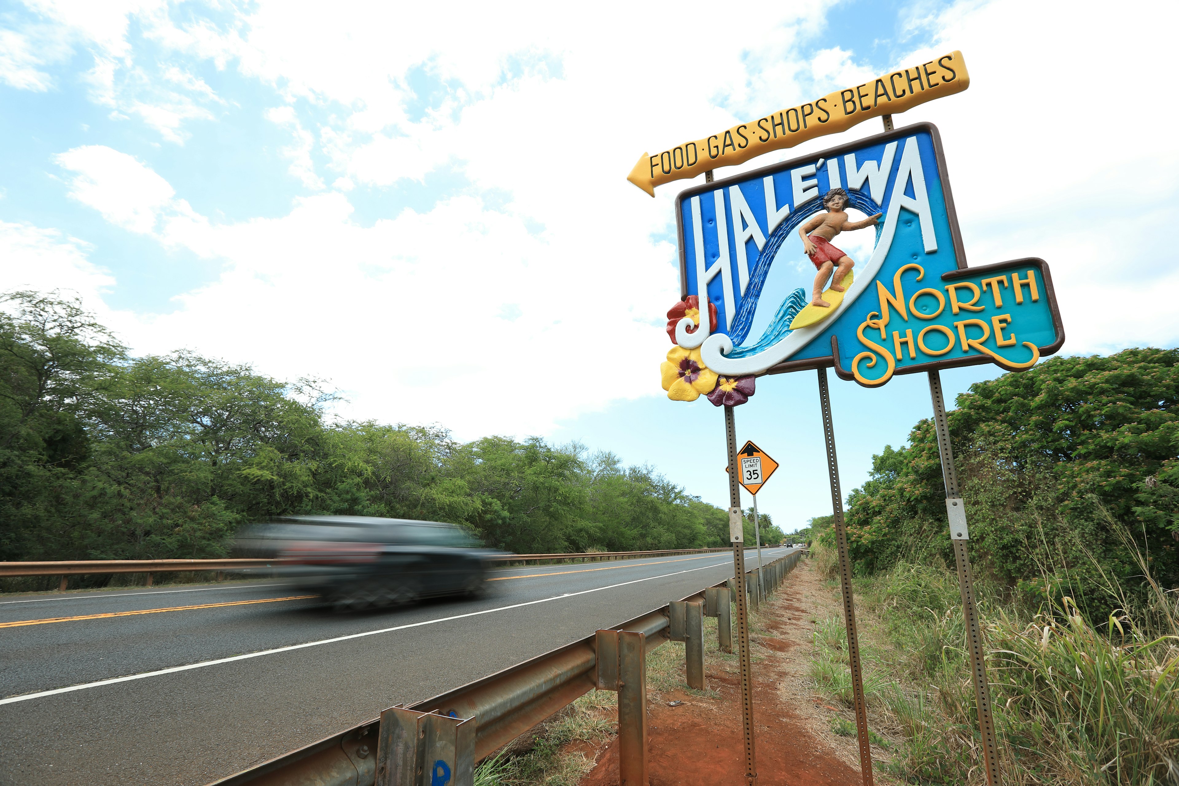 Haleiwa North Shore sign alongside a road with greenery