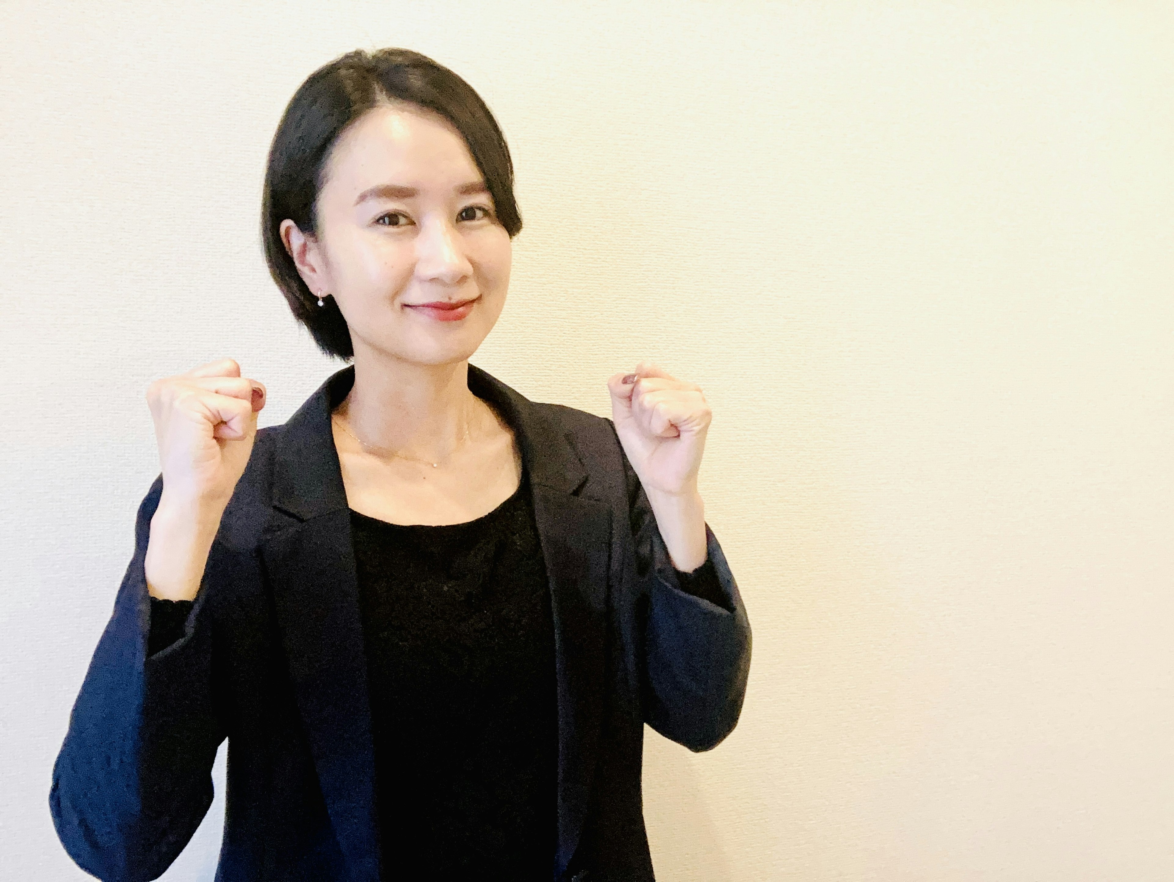 Confident woman smiling with clenched fists