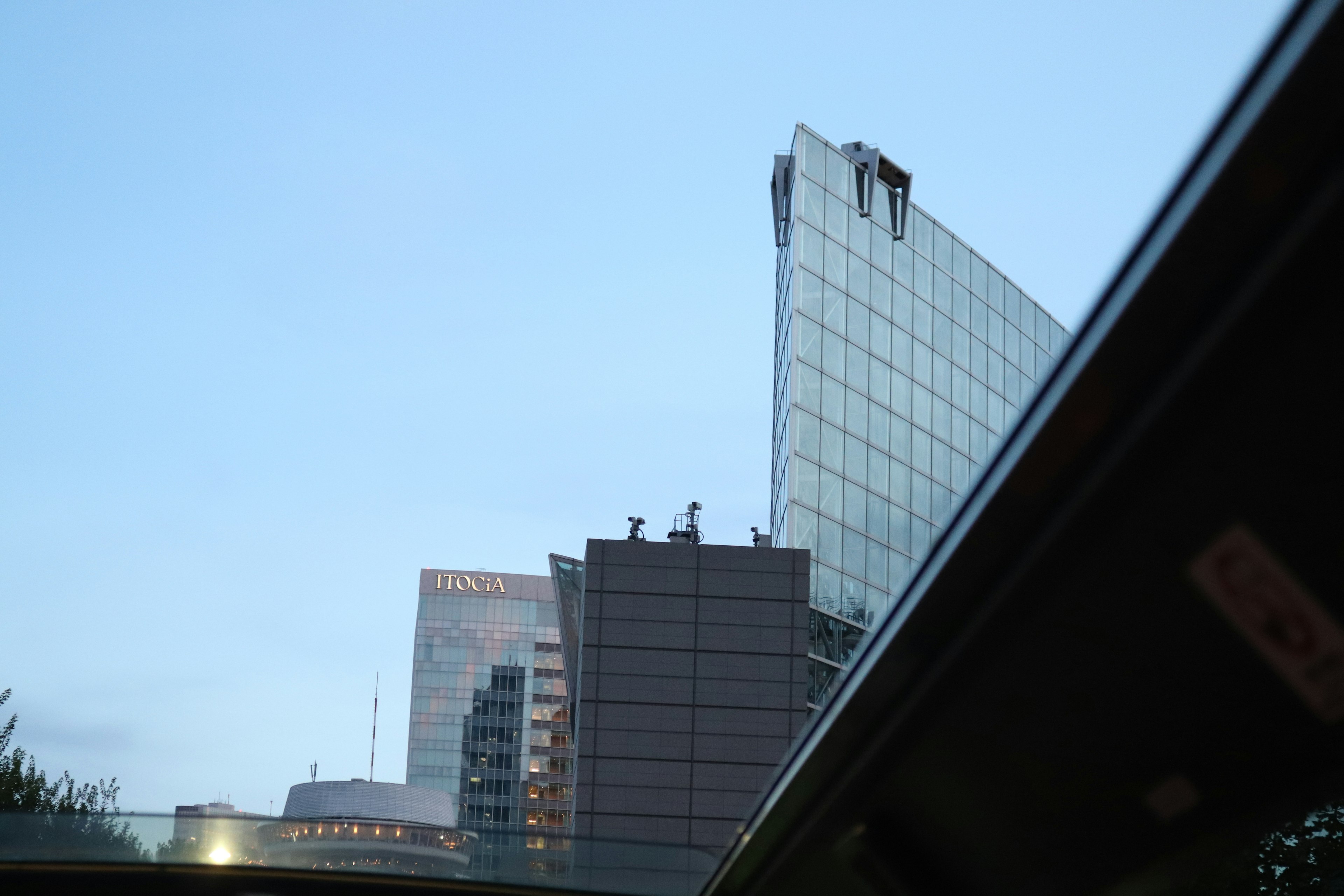 Photo of building tops against a clear blue sky