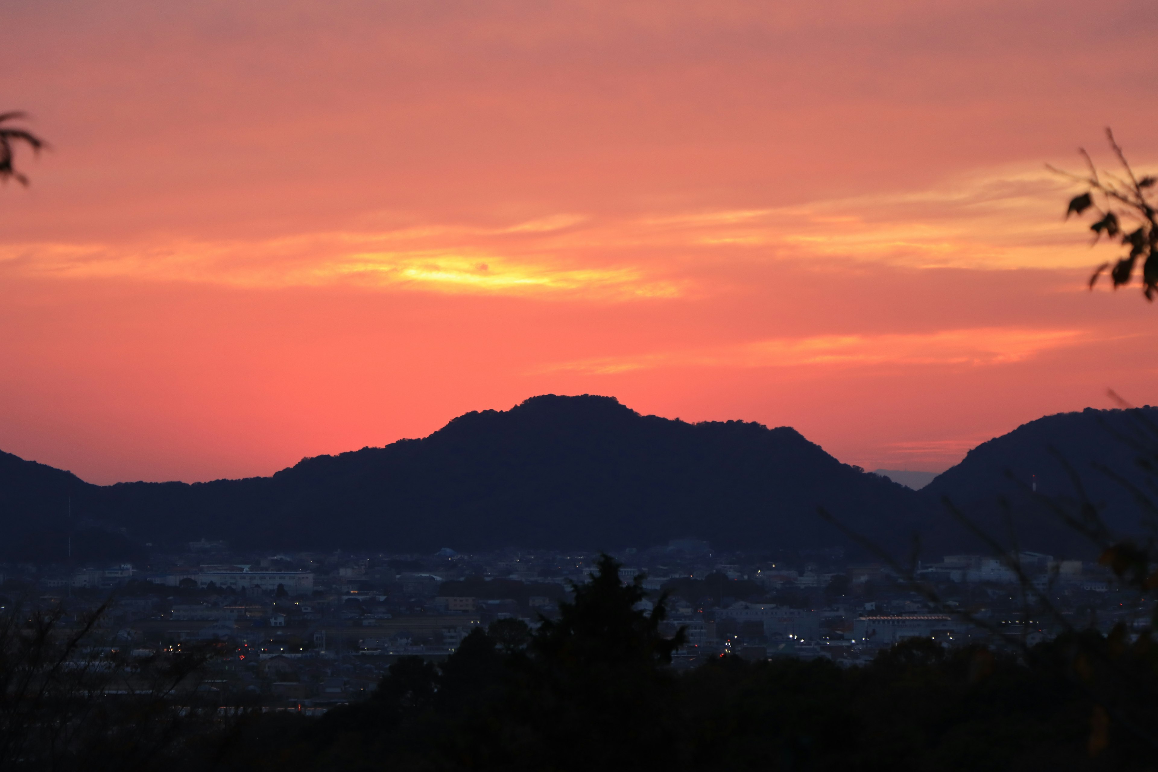 日落时山脉的轮廓和城市灯光