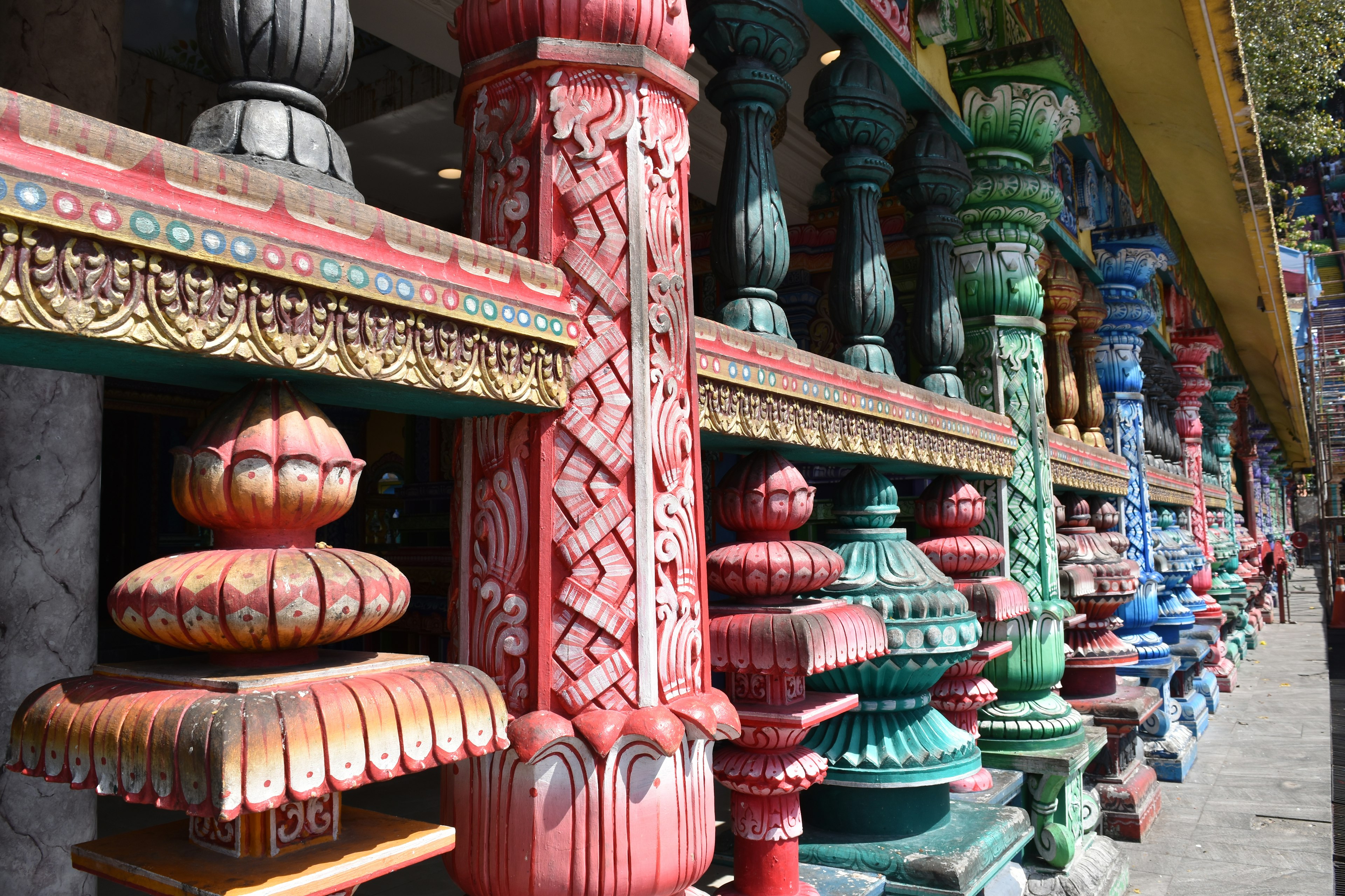 Vibrantly decorated pillars in a traditional building exterior