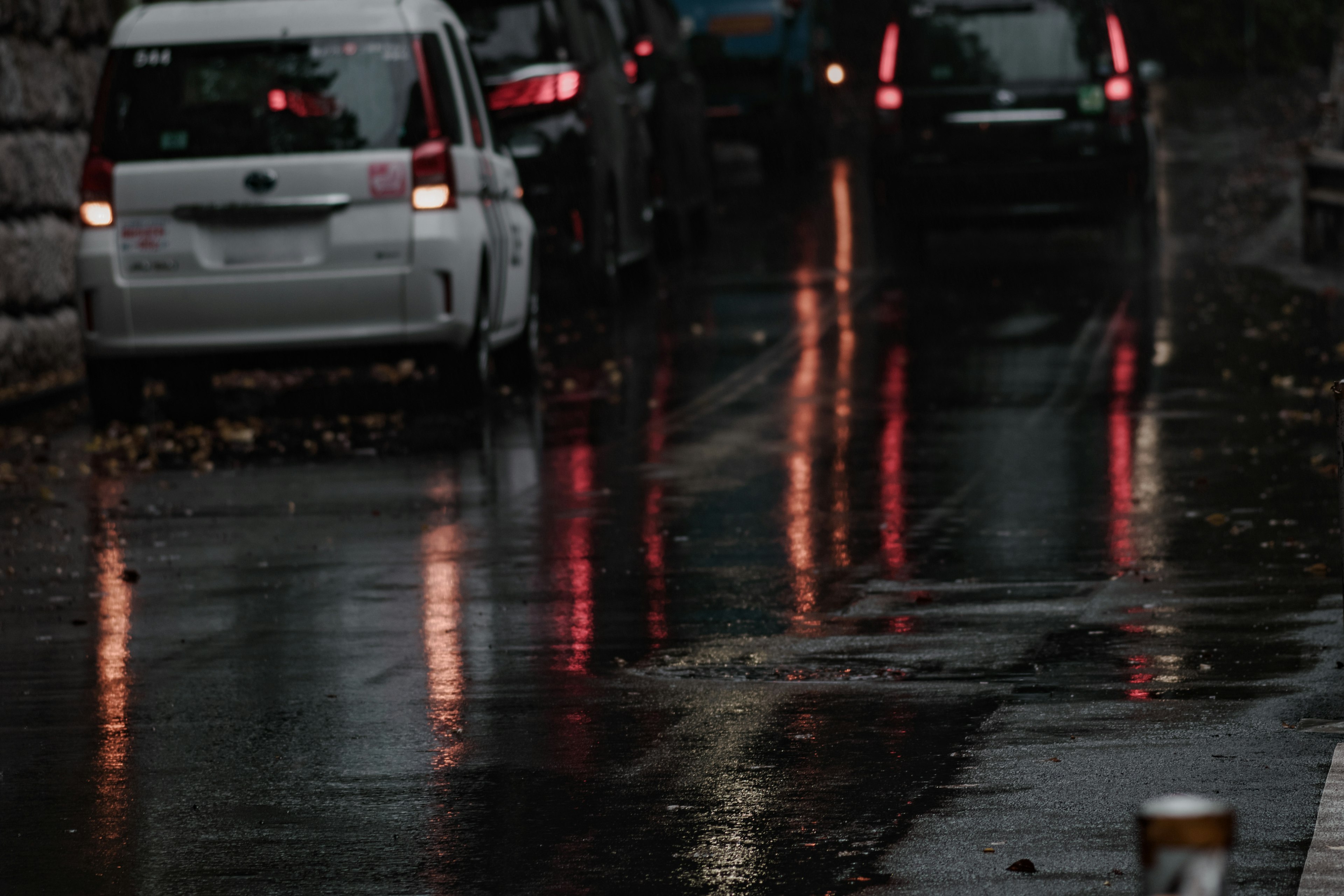 Cars reflected in a rain-soaked street