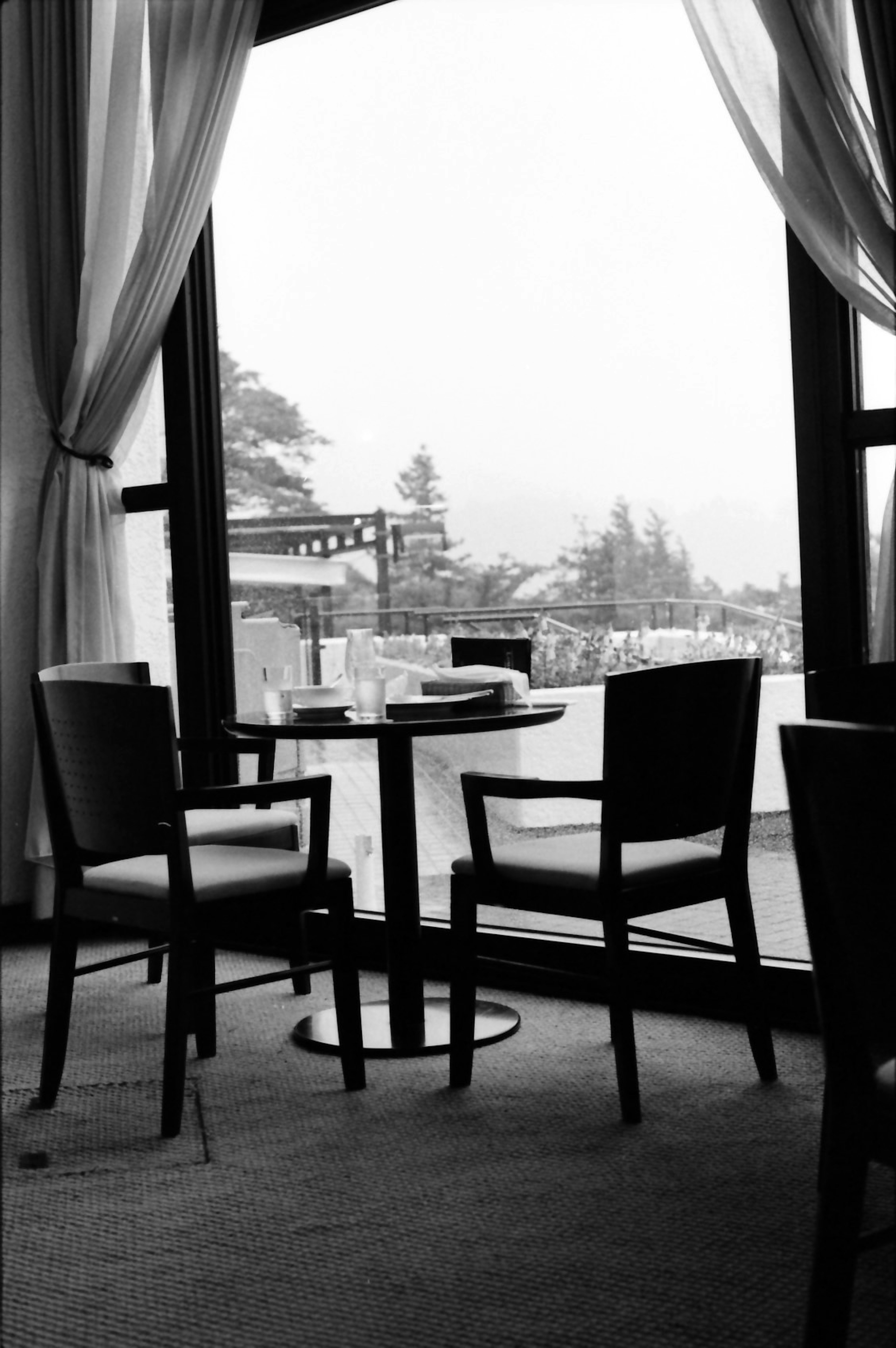 Black and white cafe setting with a view through the window