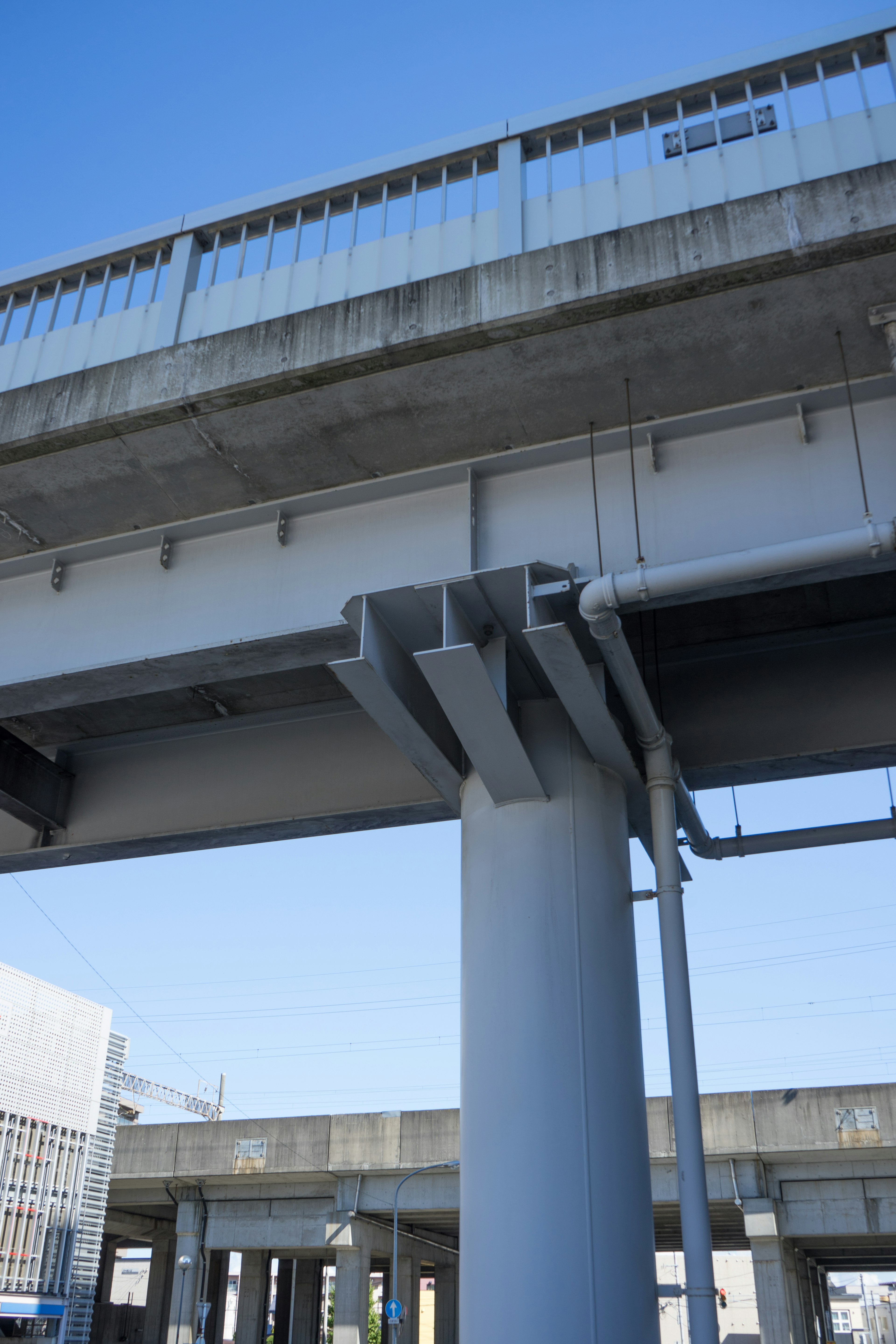 View of a elevated bridge structure from below showing supports and beams