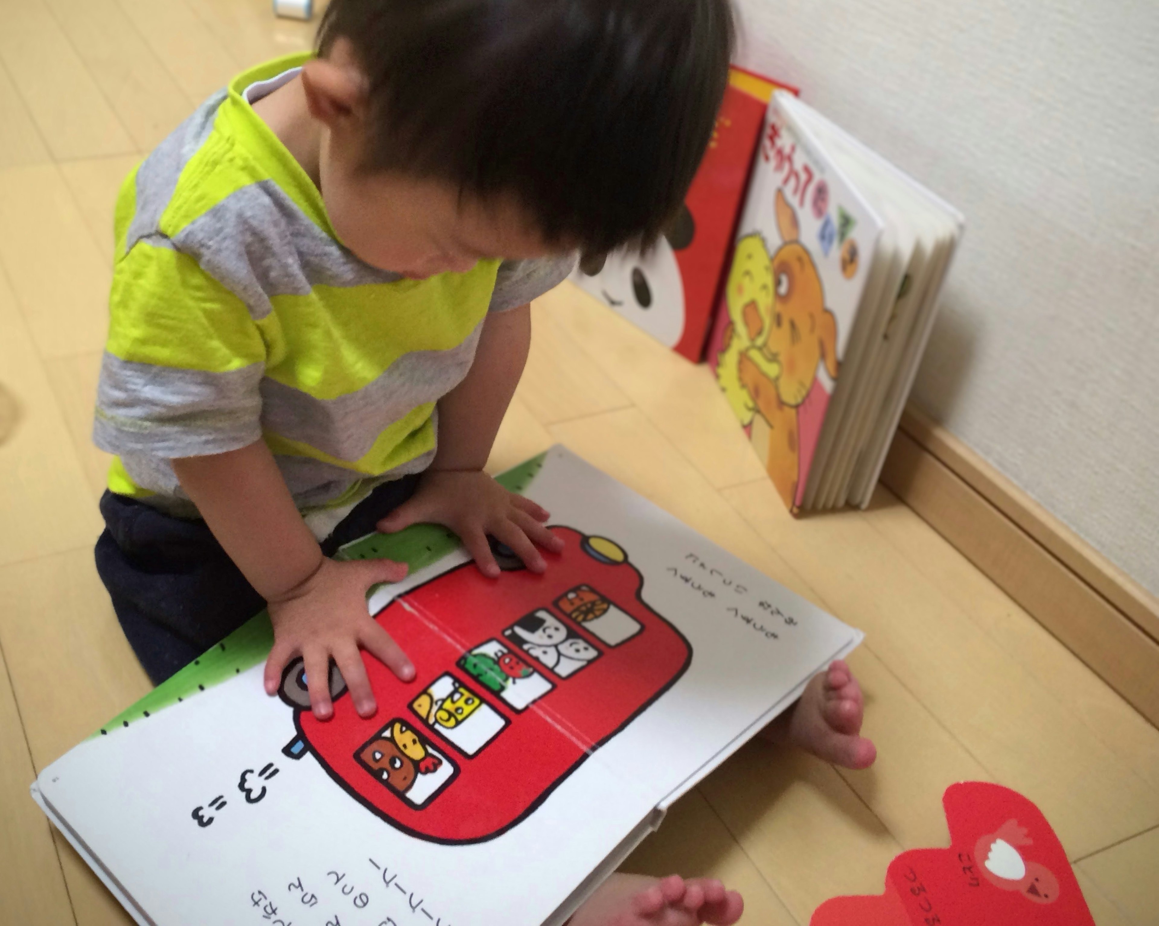 A child engaged with a colorful book while playing