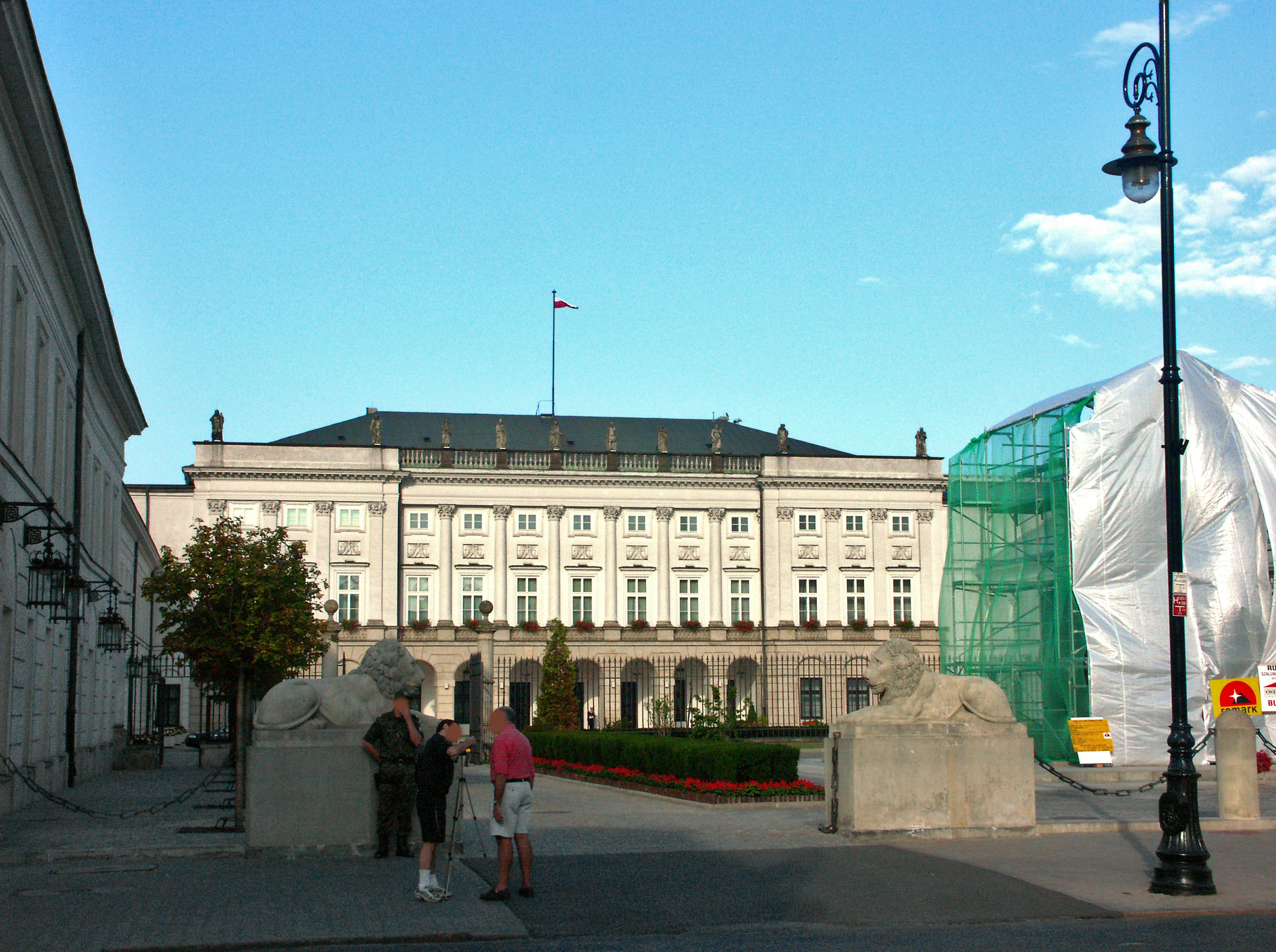 Historic building with people in front and blue sky