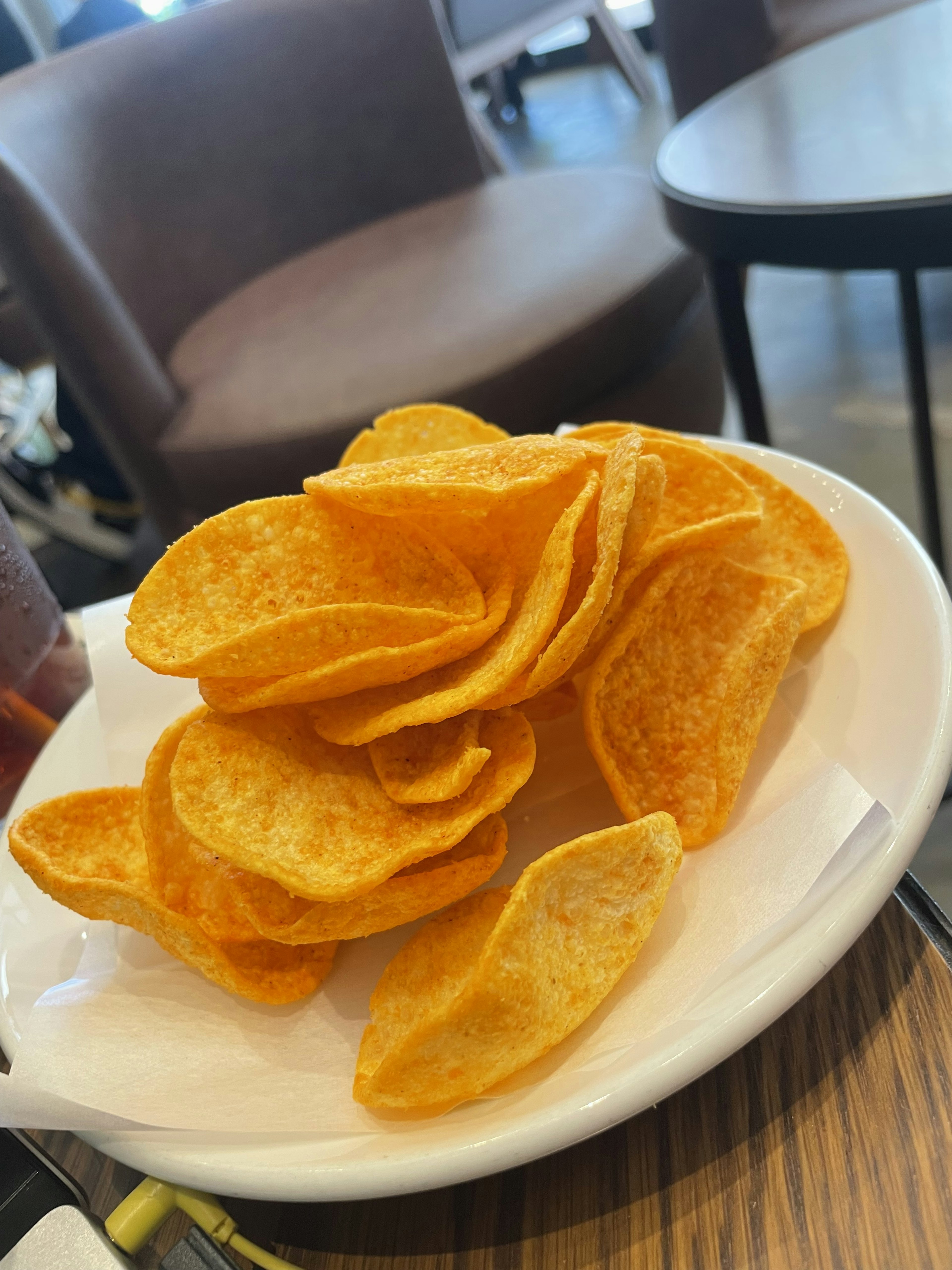 Ein Haufen knuspriger Kartoffelchips auf einem weißen Teller