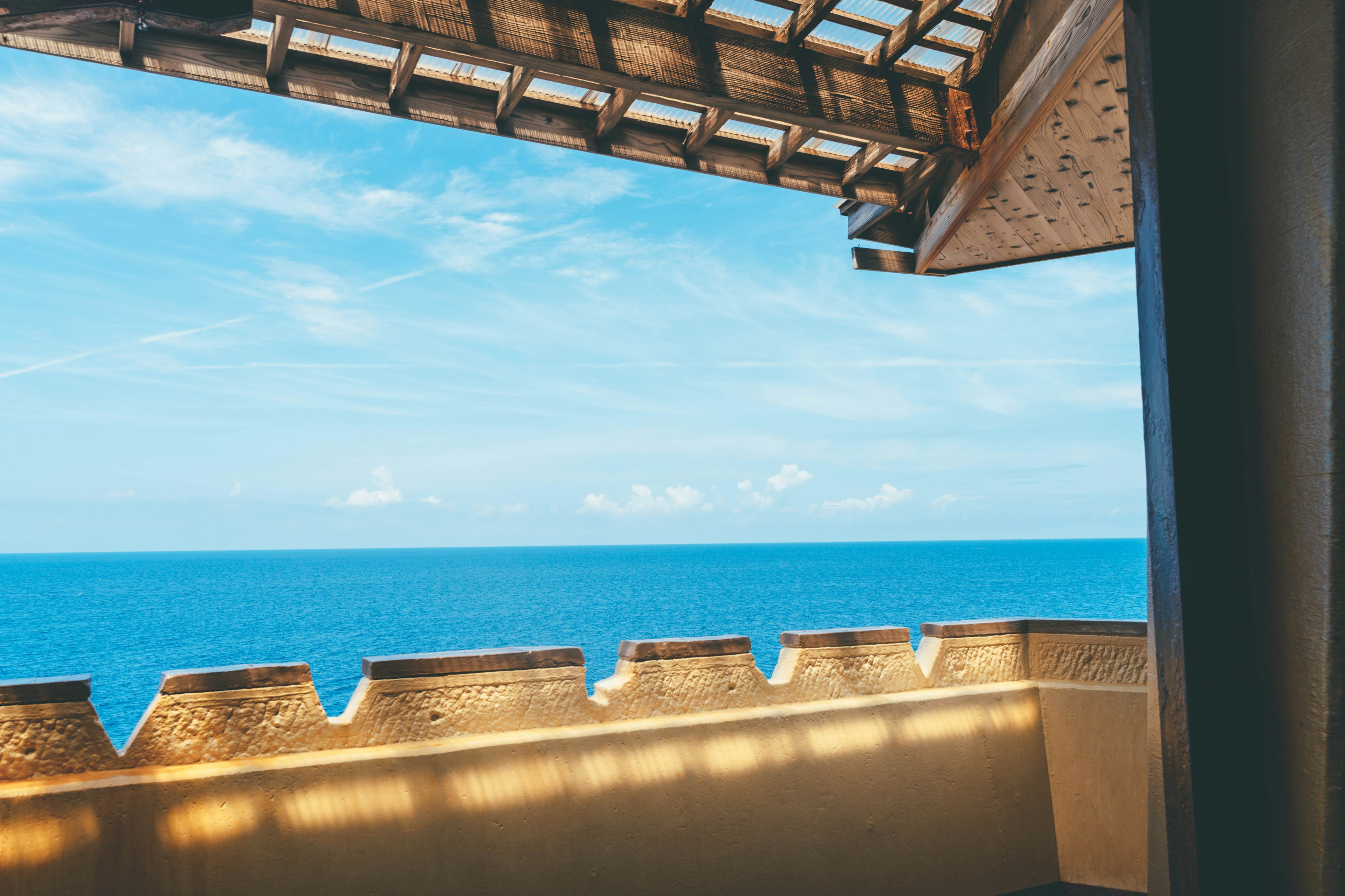 View from a balcony overlooking the blue sea and sky