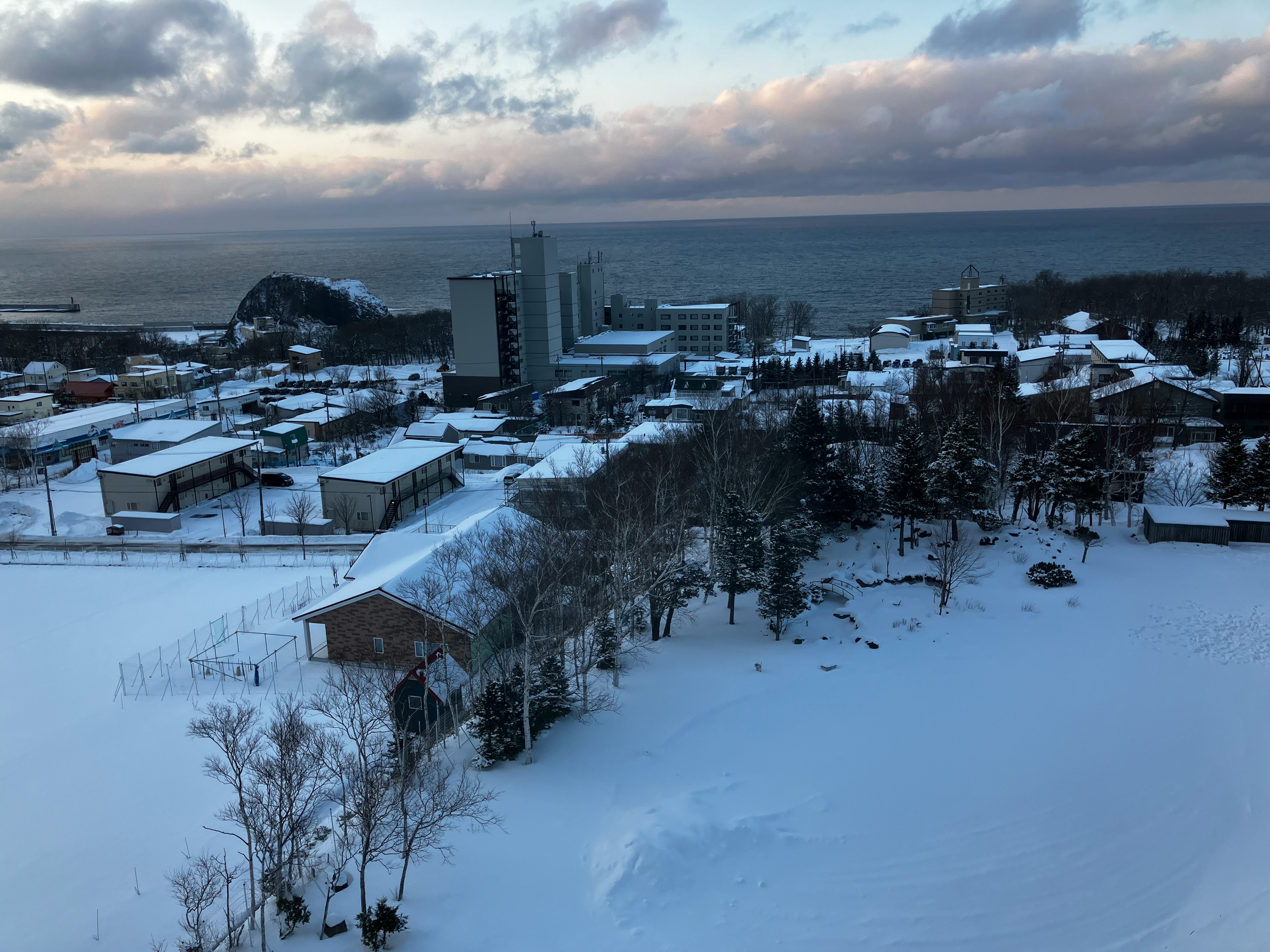 Paysage urbain enneigé avec vue sur la mer au loin