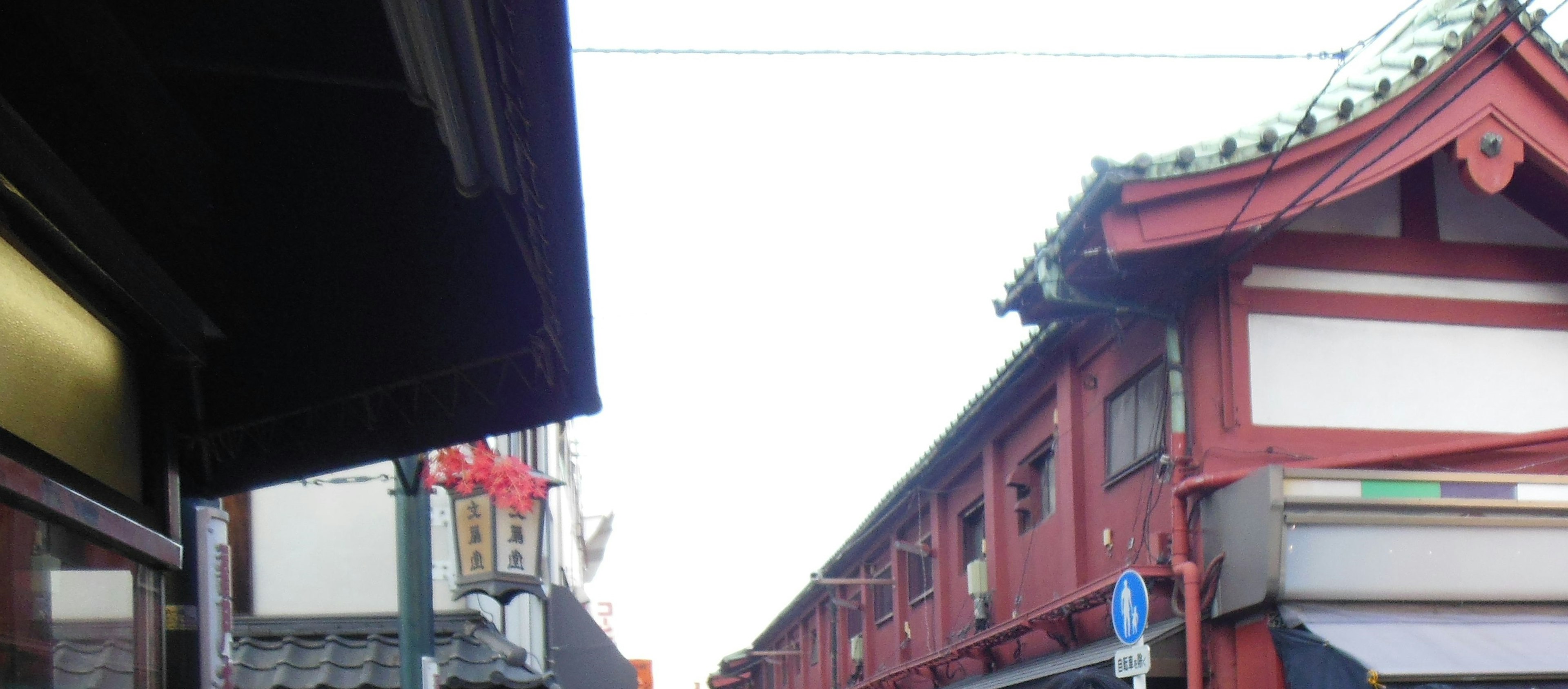 Traditional Japanese street scene featuring red buildings