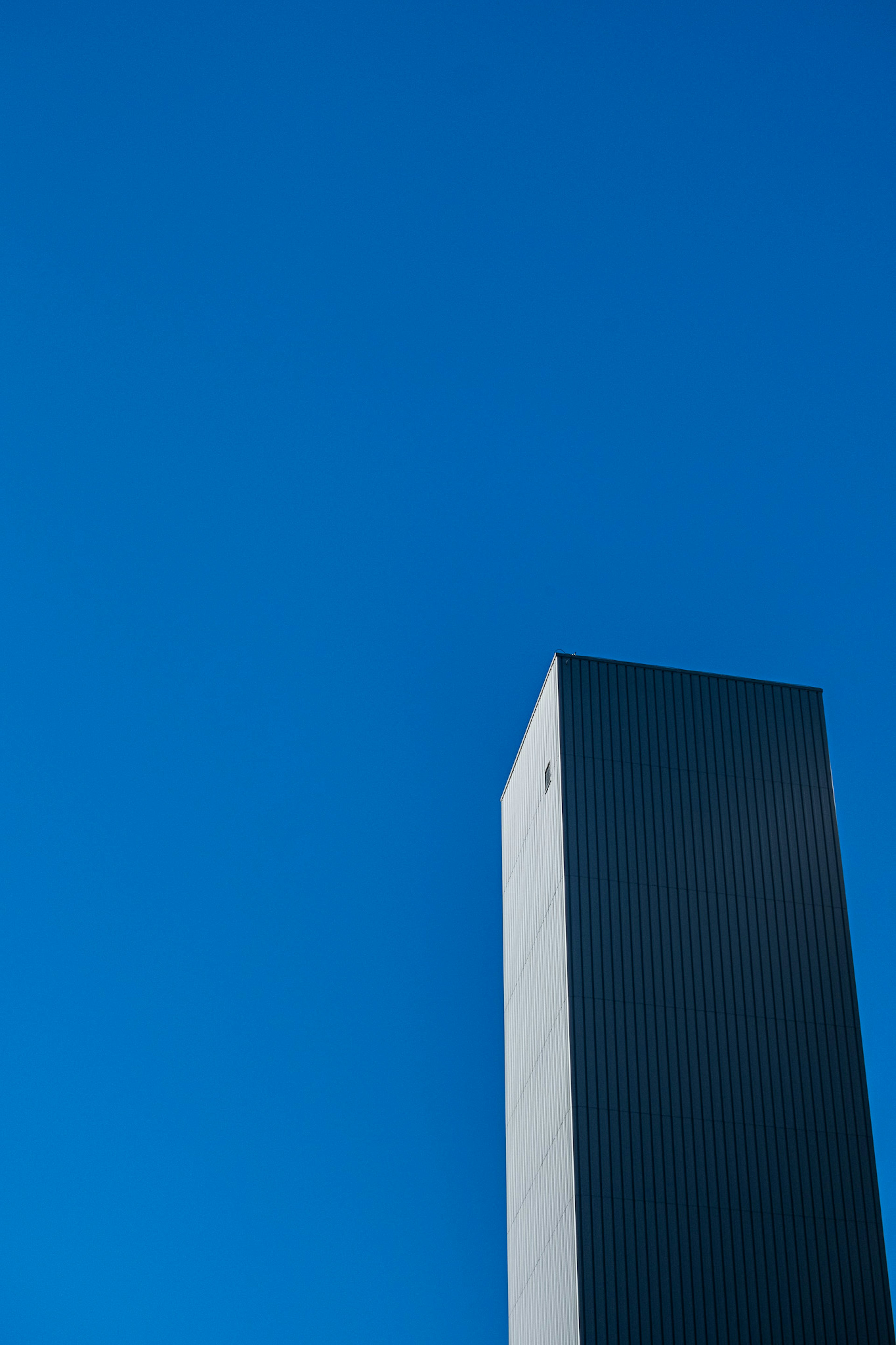 青空にそびえる高層ビルの写真