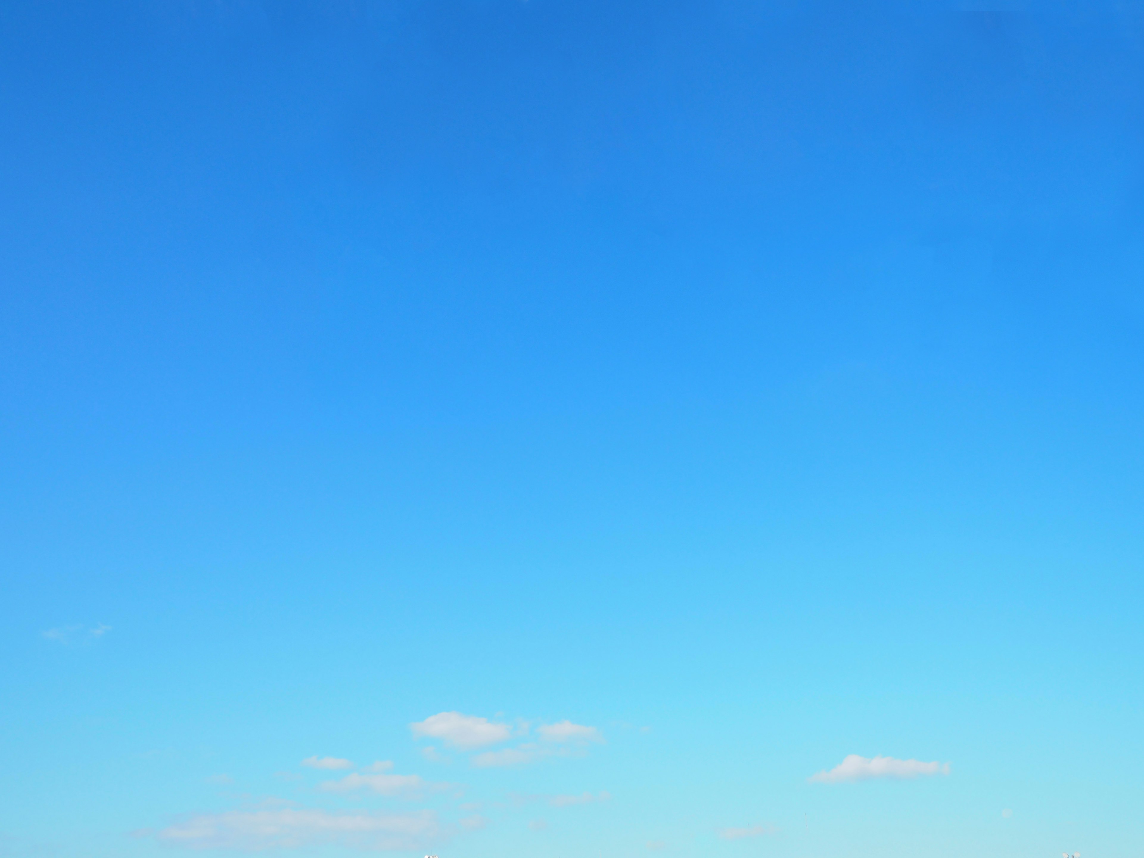 Clear blue sky with a few clouds