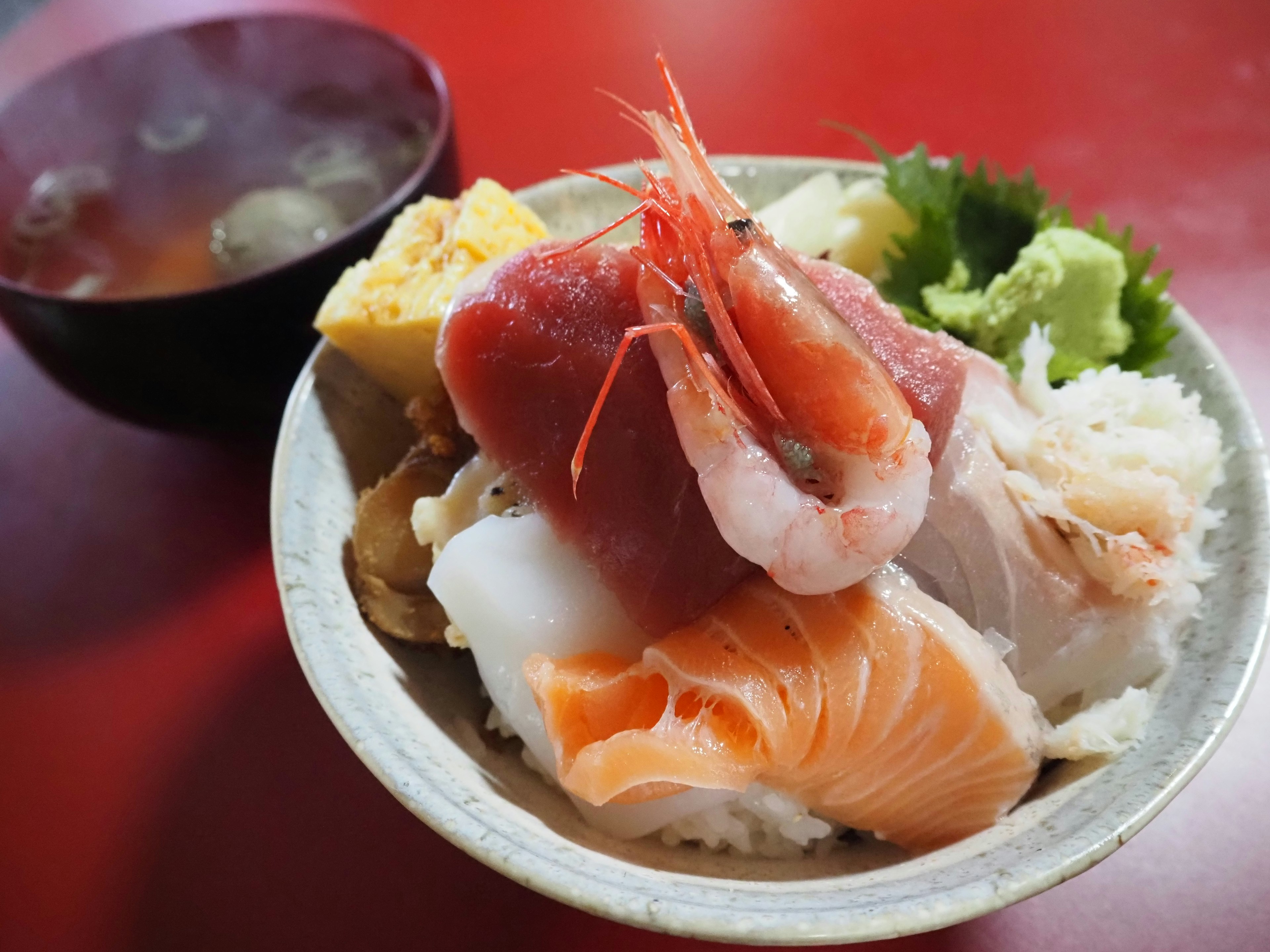 Bowl of assorted sashimi with rice and miso soup