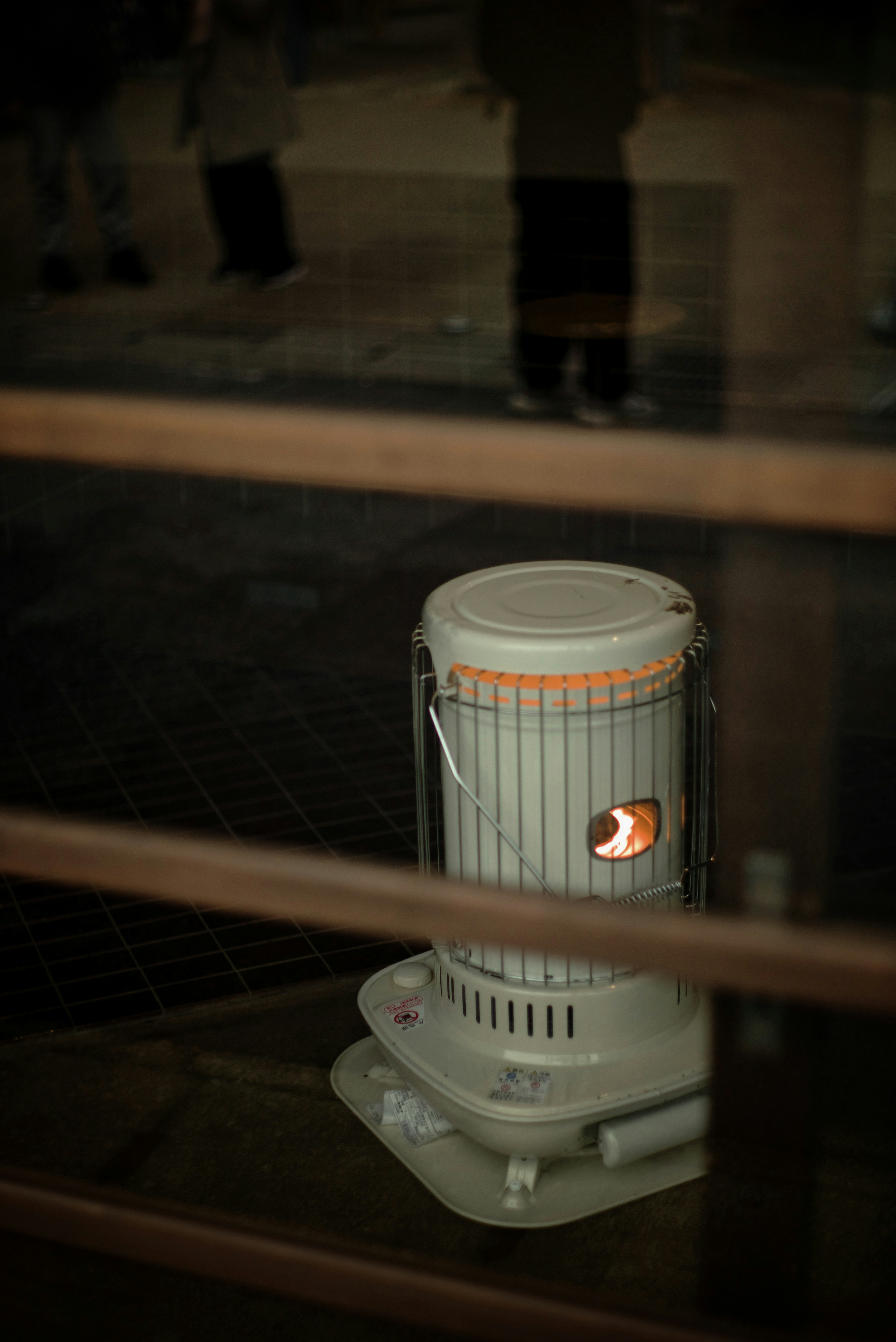 White heater visible through a window warm light glowing inside