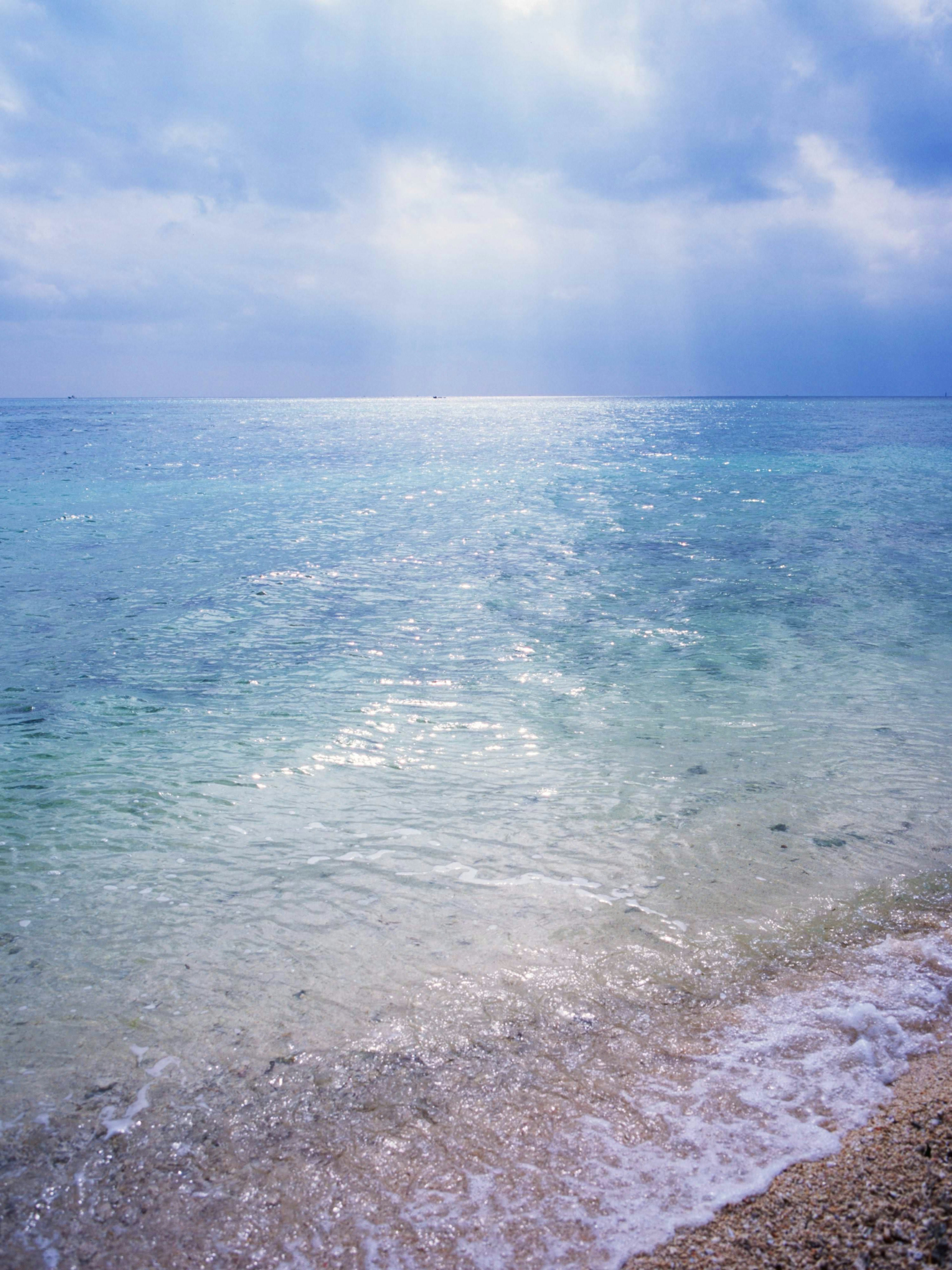 Calm sea with blue sky and gentle waves