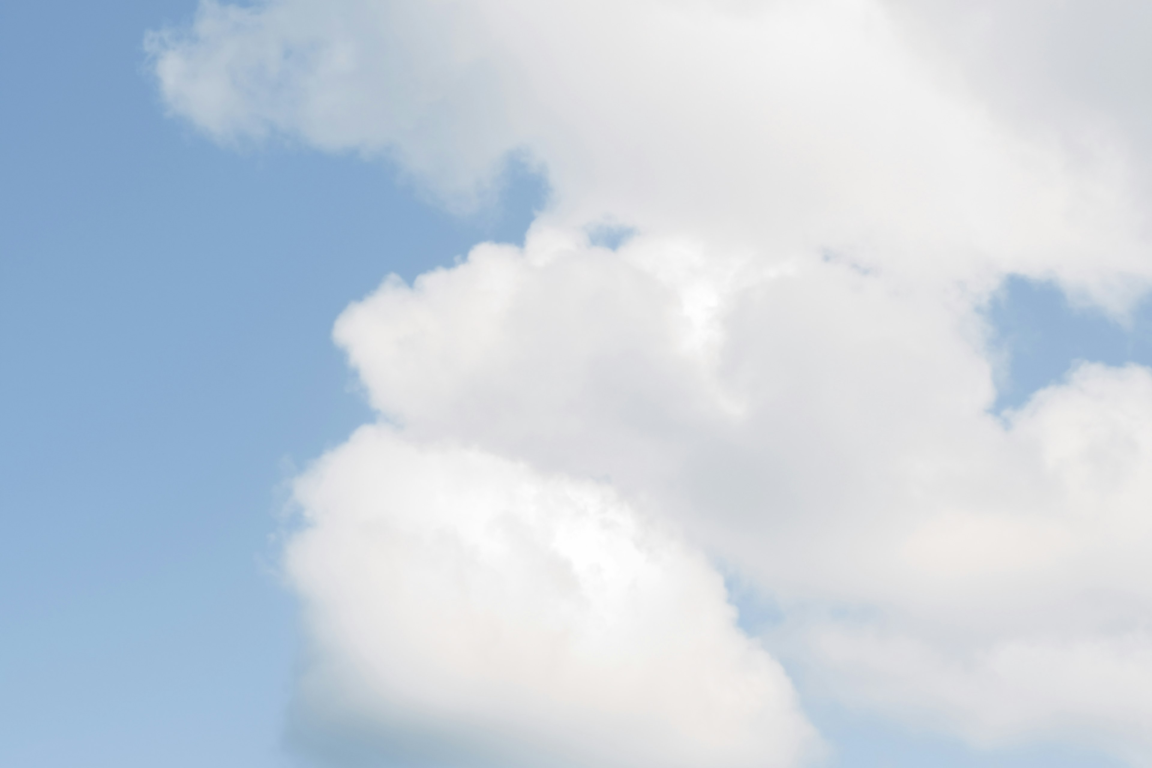 Calm scene of white clouds floating in a blue sky