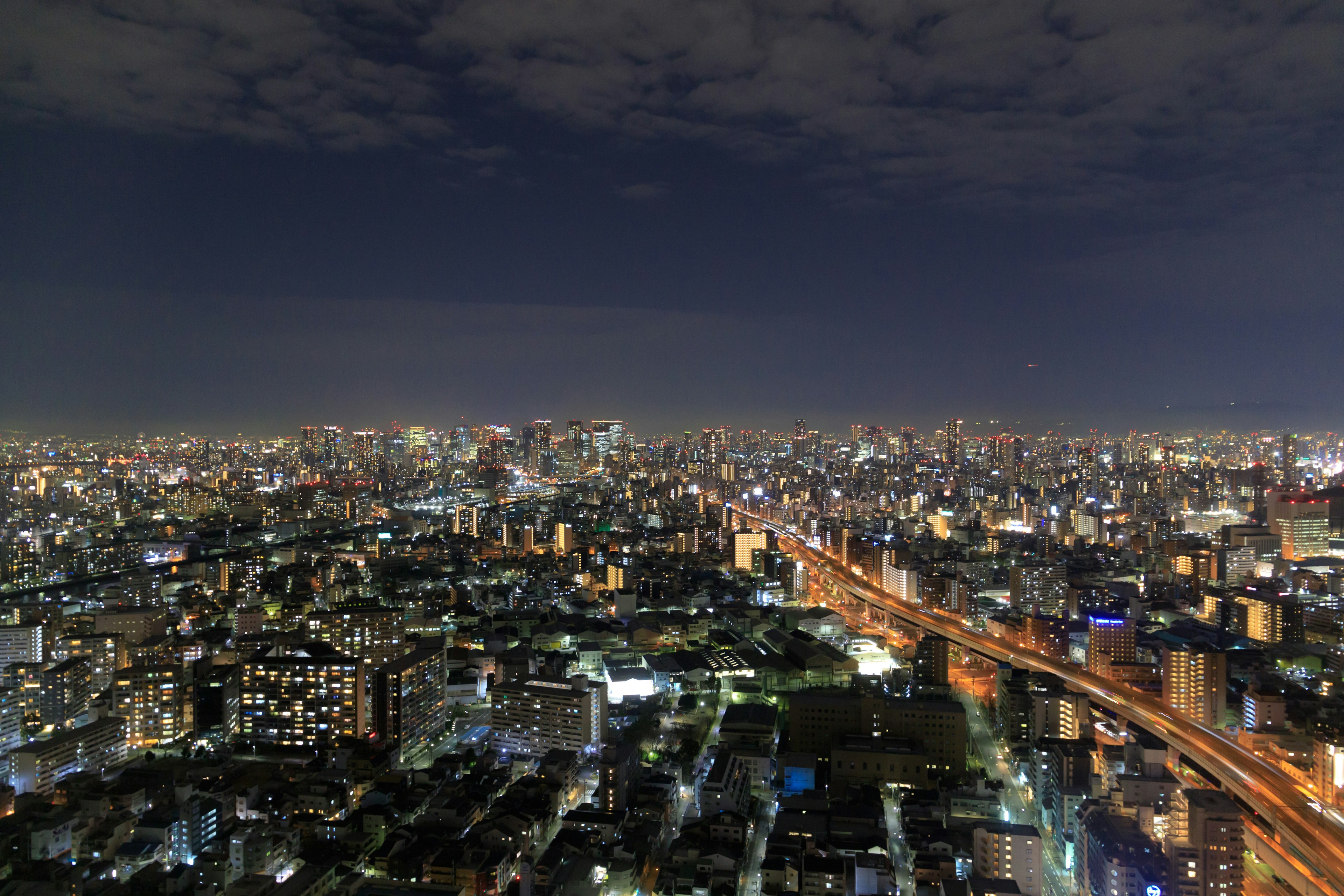 Night cityscape with skyscrapers and illuminated roads