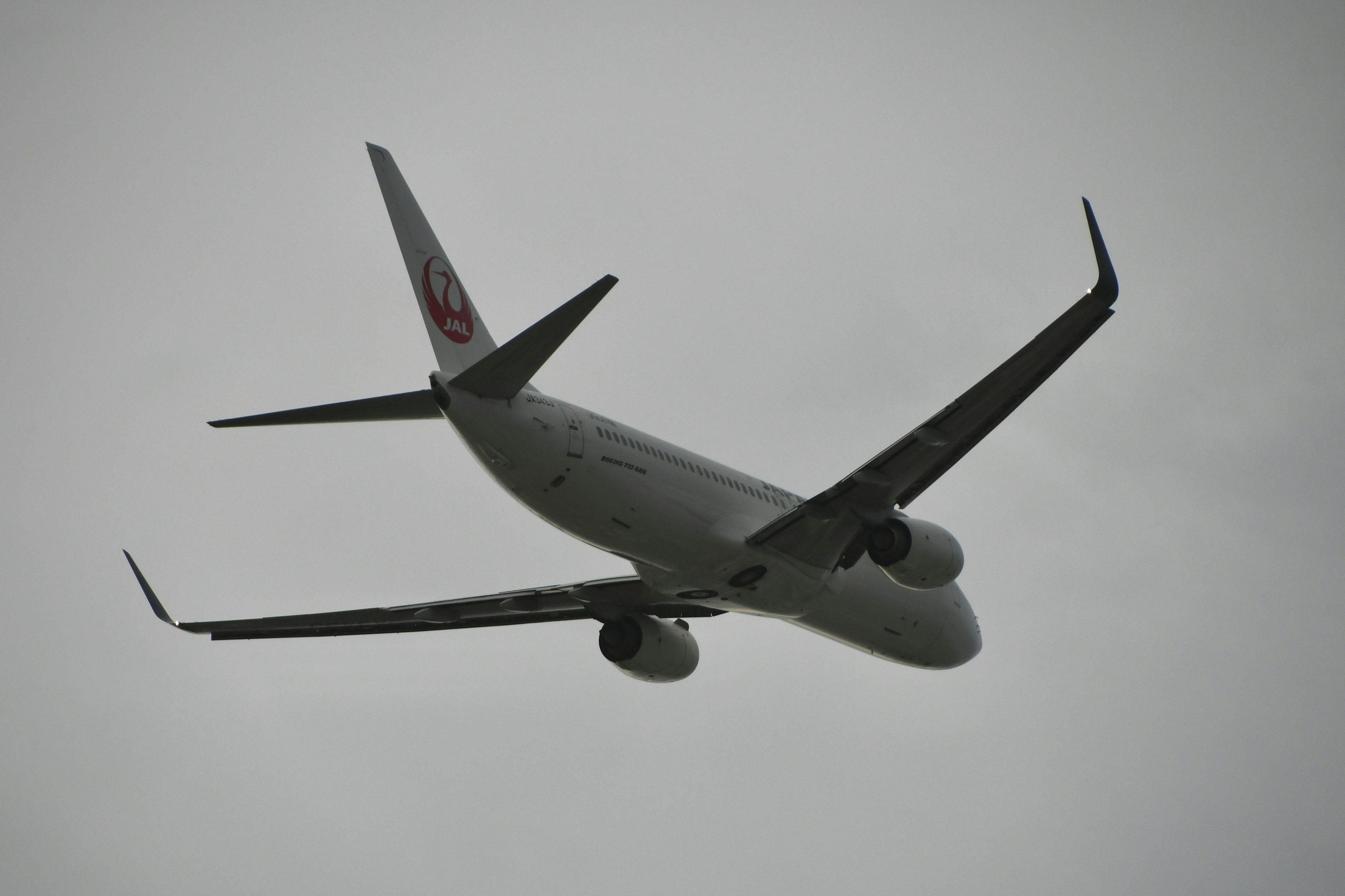 Airplane flying through cloudy sky