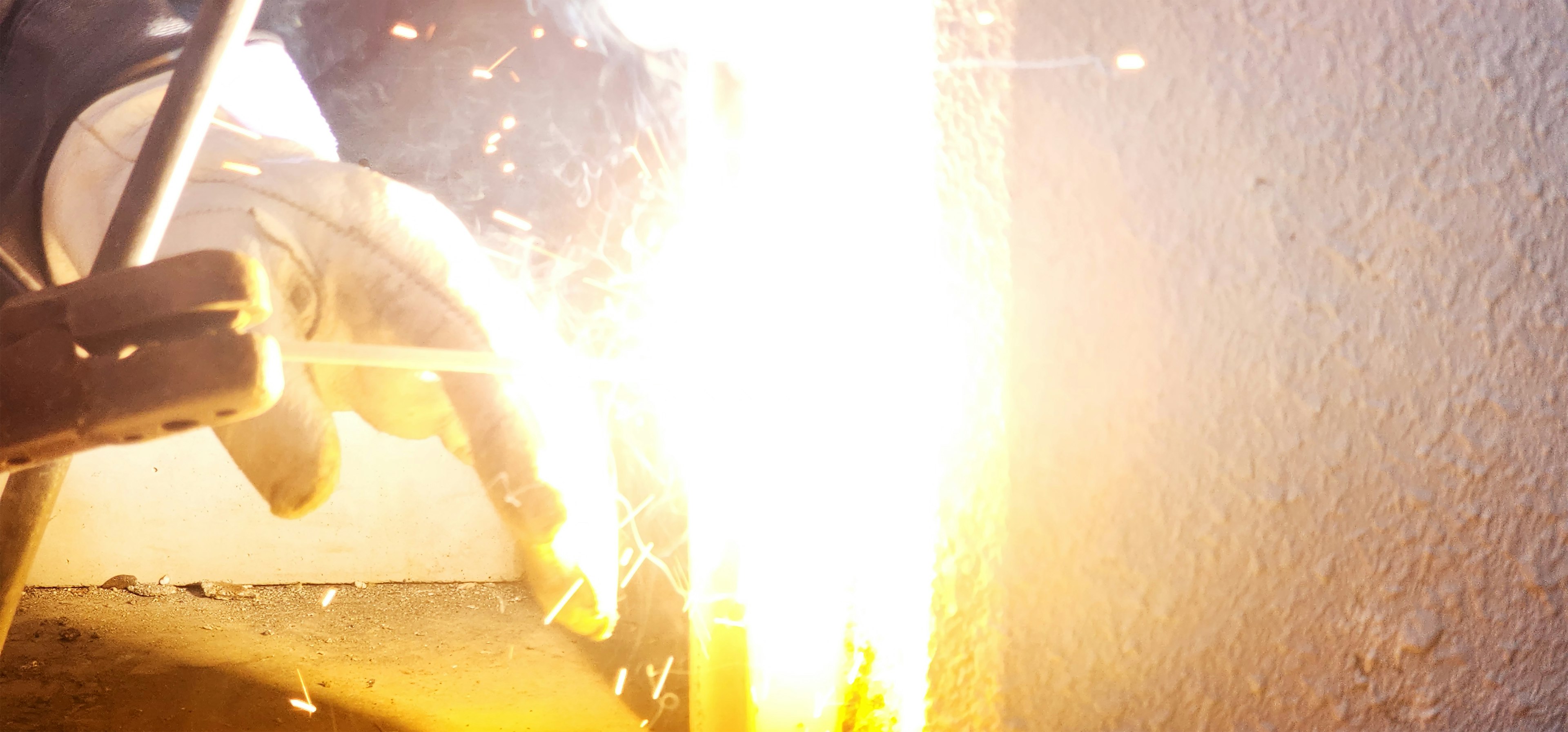 Welding process with sparks flying from the work area