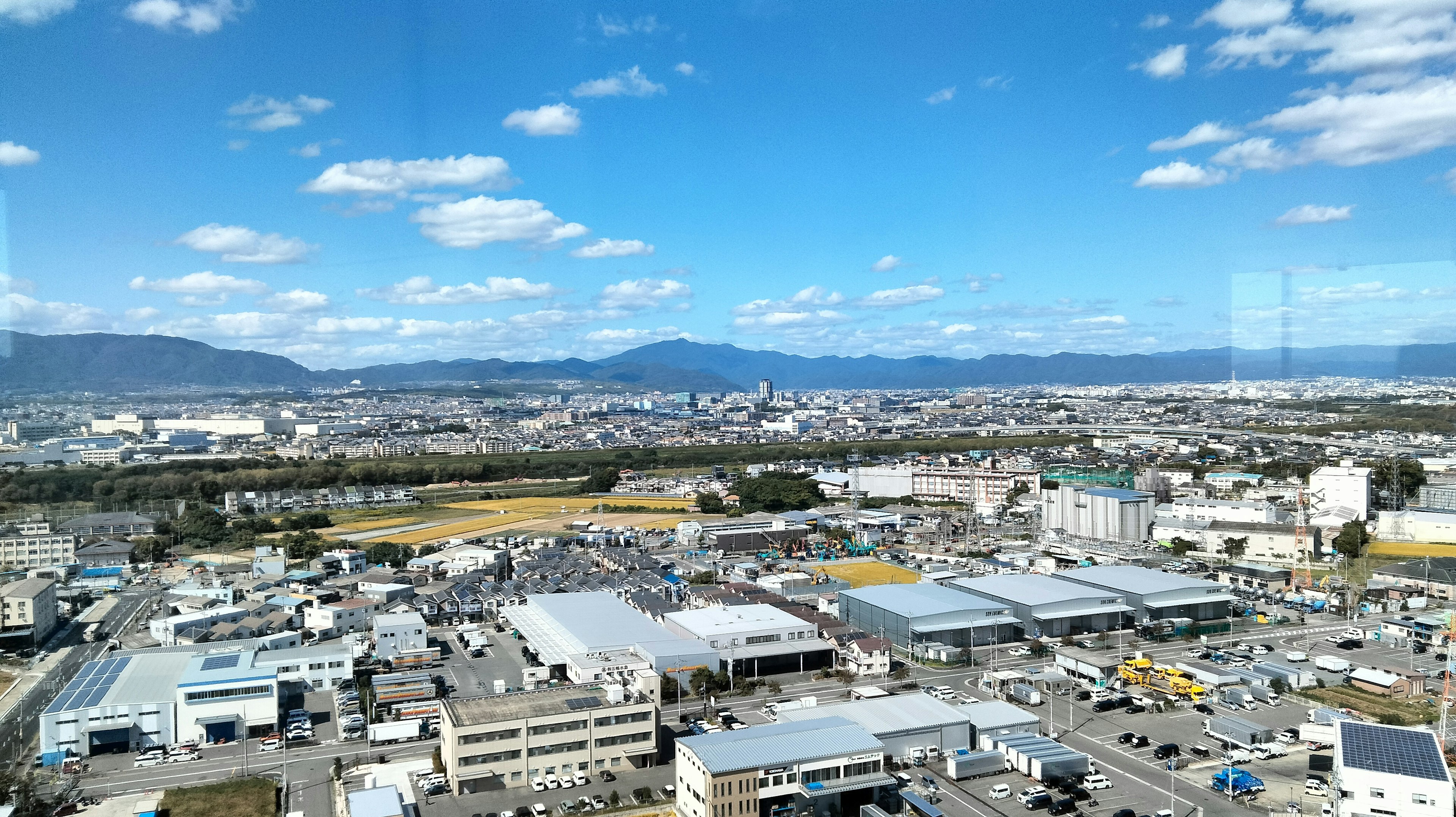 Stadtansicht mit blauem Himmel und Bergen im Hintergrund