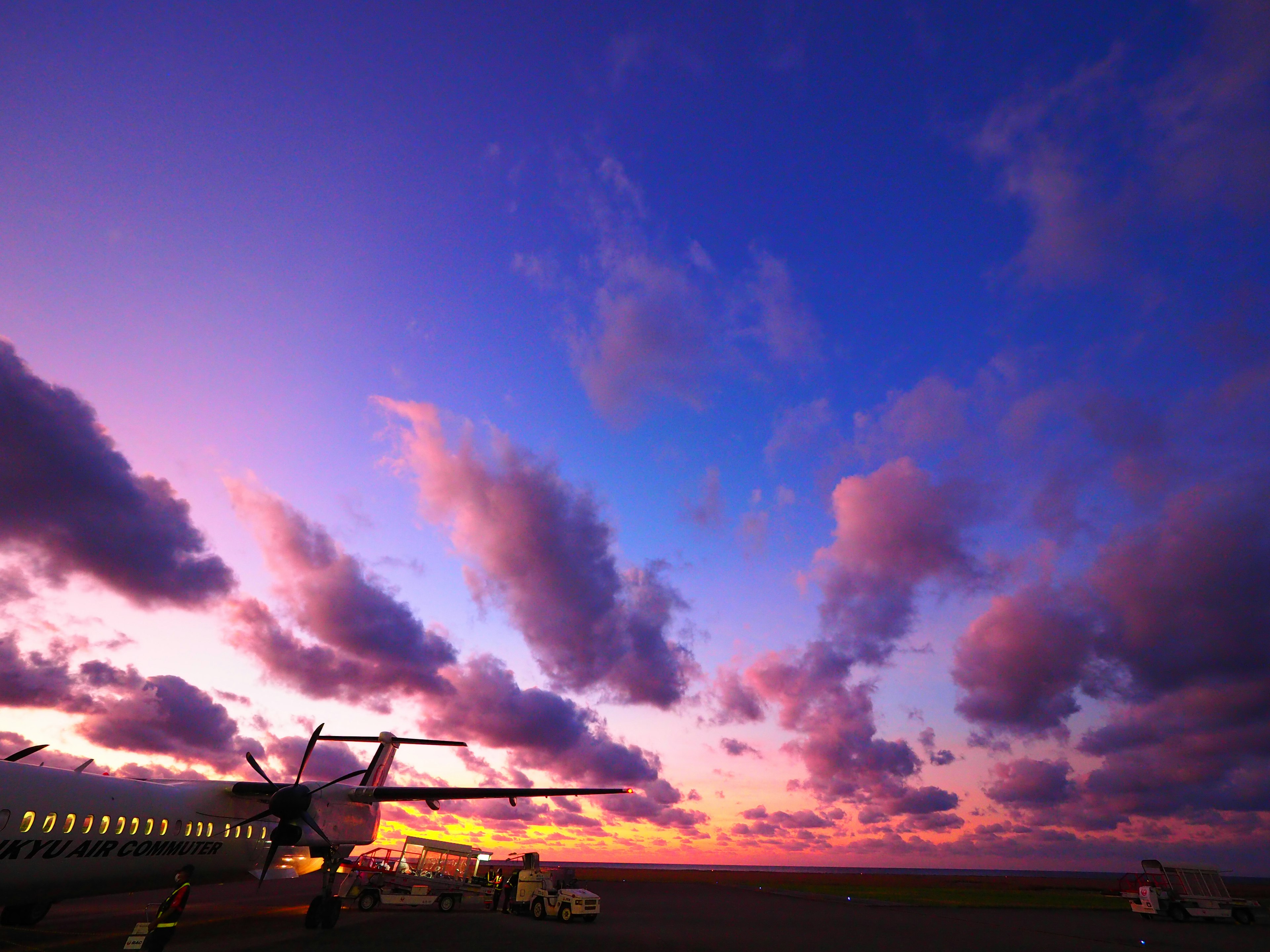 Aviones en la pista con un cielo de atardecer vibrante