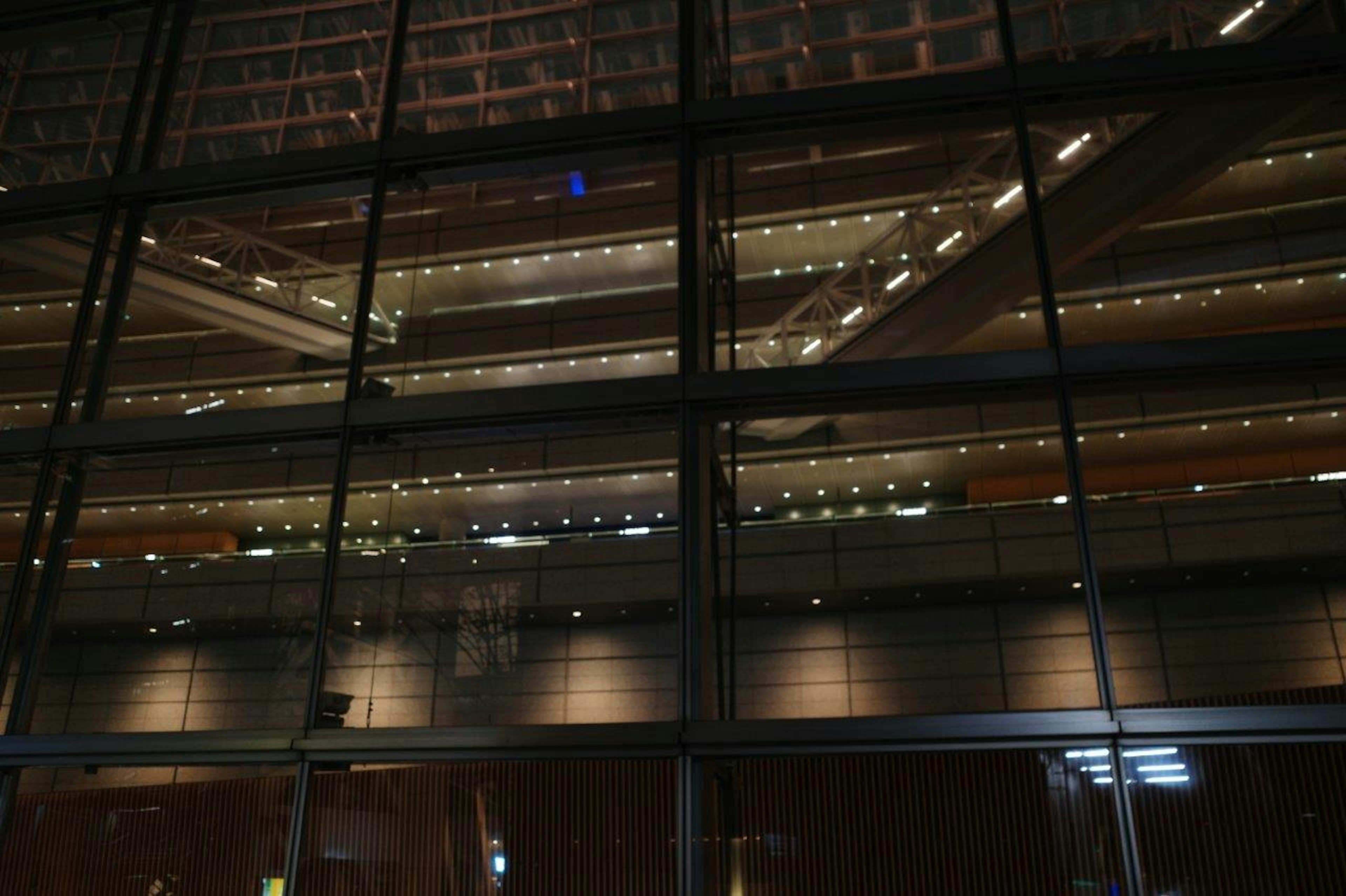 Illuminated interior levels of a building seen through glass at night