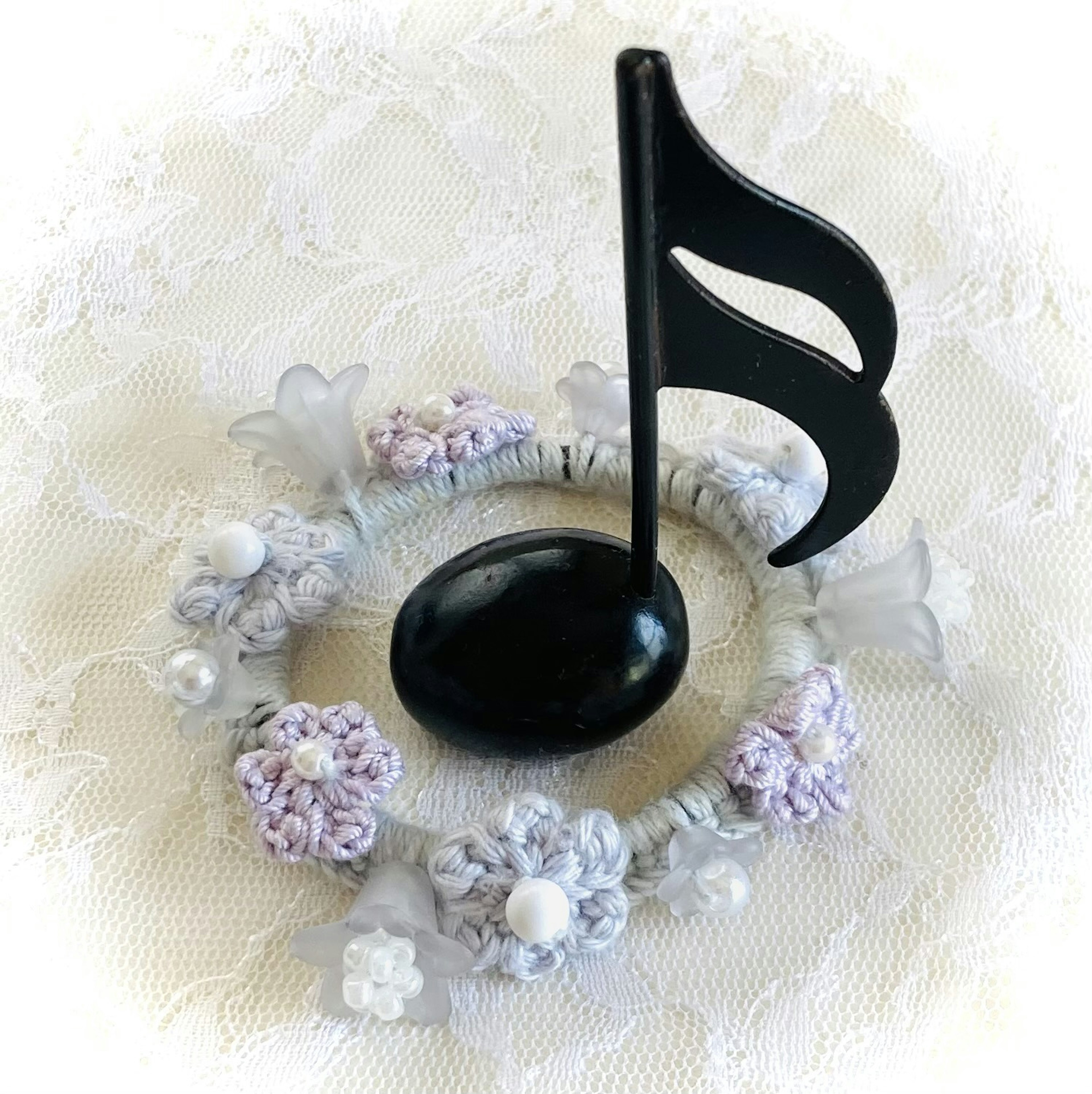 Black musical note centerpiece with floral wreath