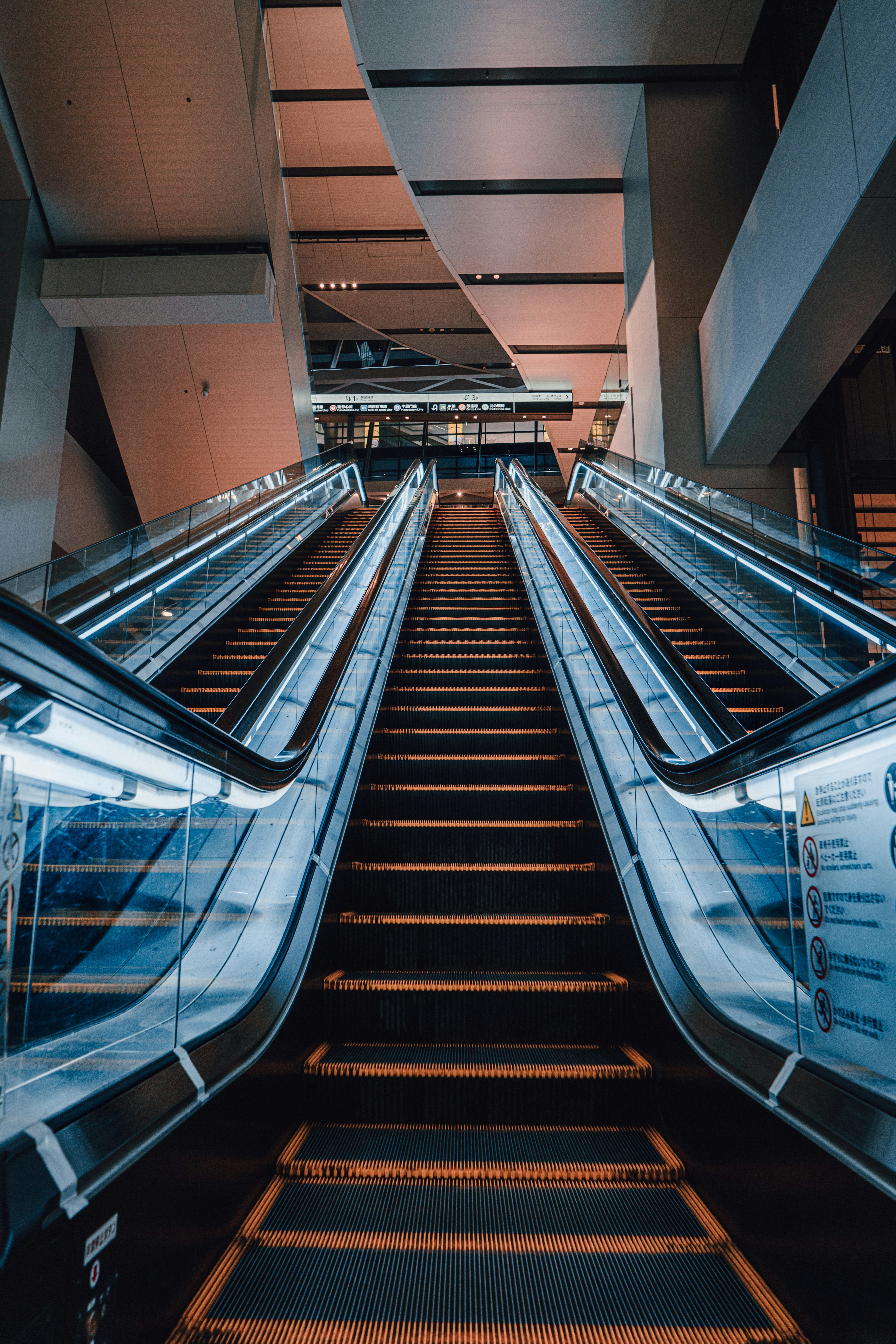 Modern escalator interior view with bright lighting and sleek design