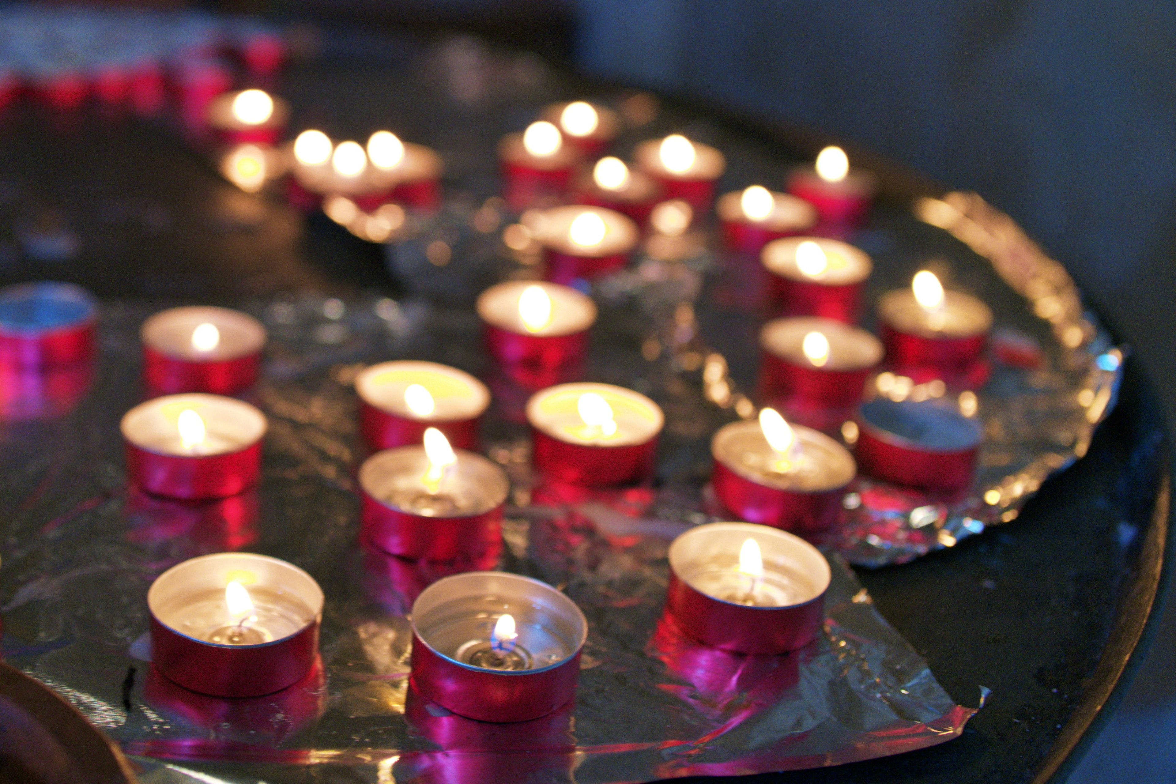 A beautiful scene of lit red candles on a surface