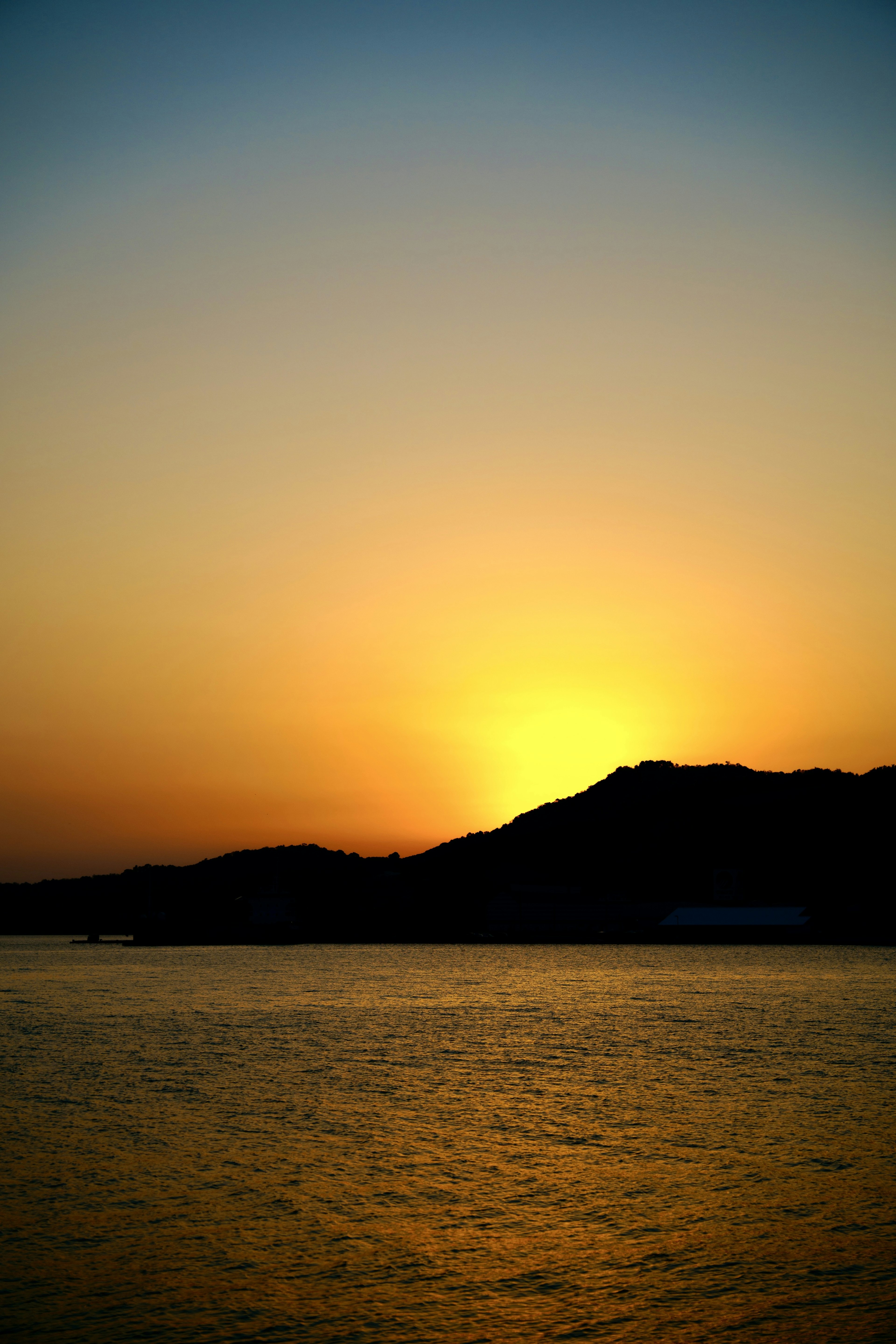 Una hermosa puesta de sol detrás de la silueta de una montaña