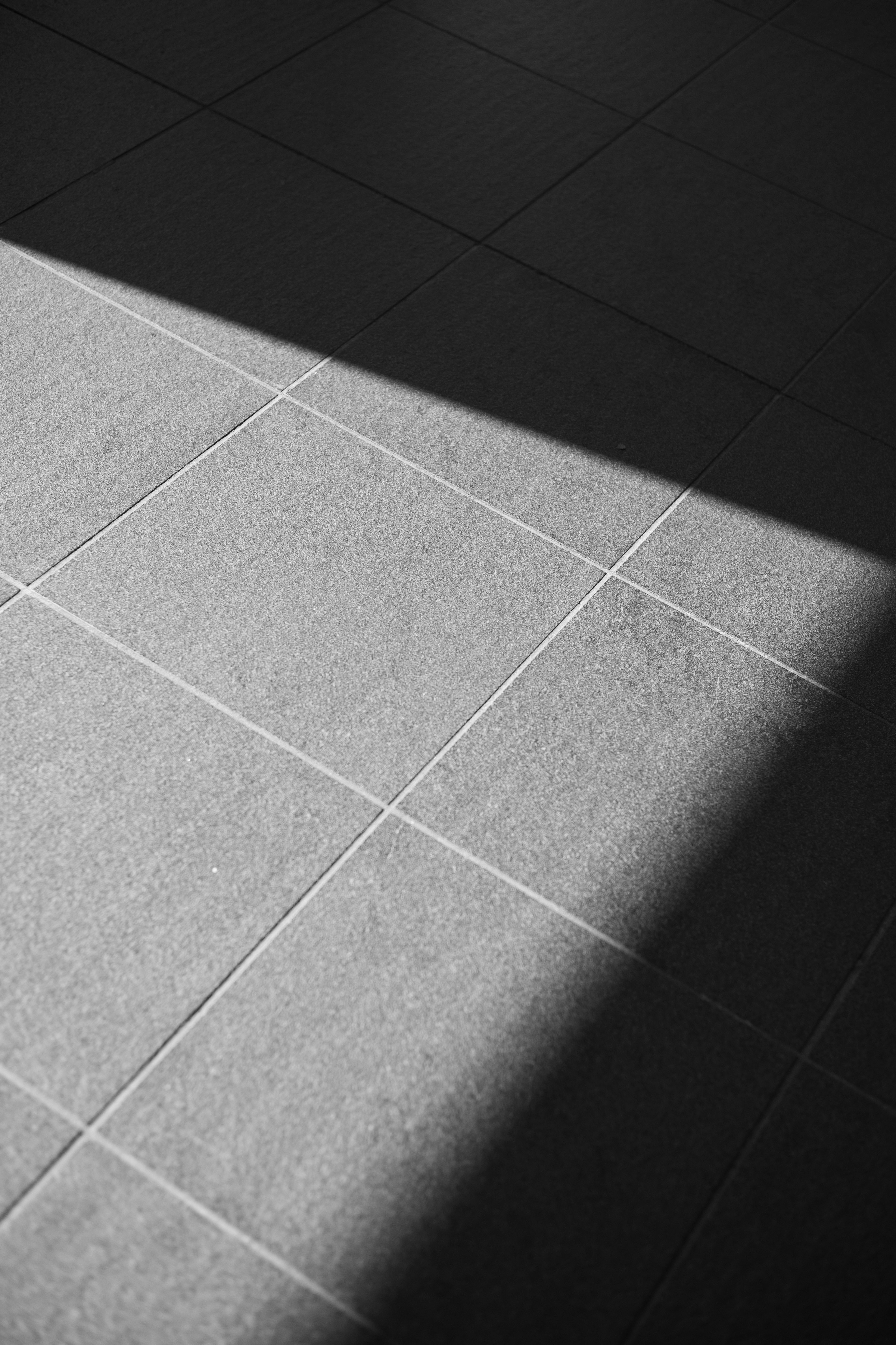 Section of tiled floor with shadows