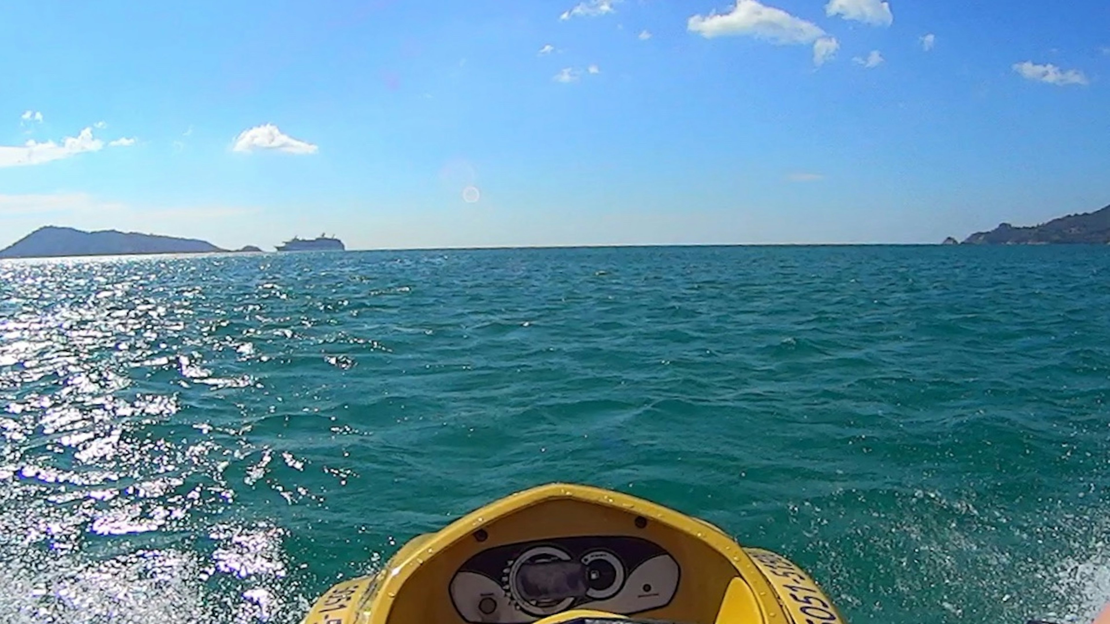 Foreground of a jet ski with a view of the blue sea and sky