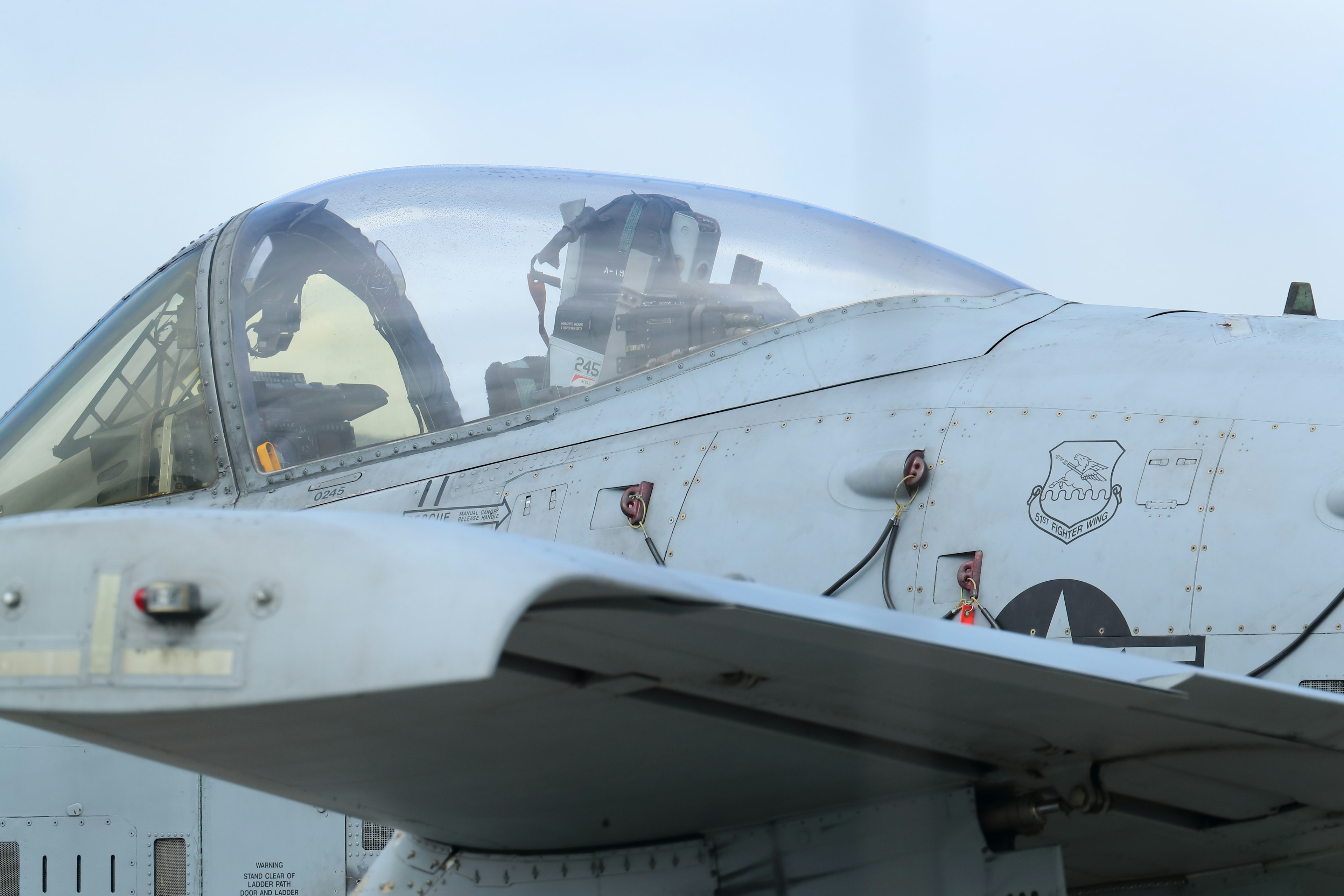 Close-up of a fighter jet cockpit with visible pilots