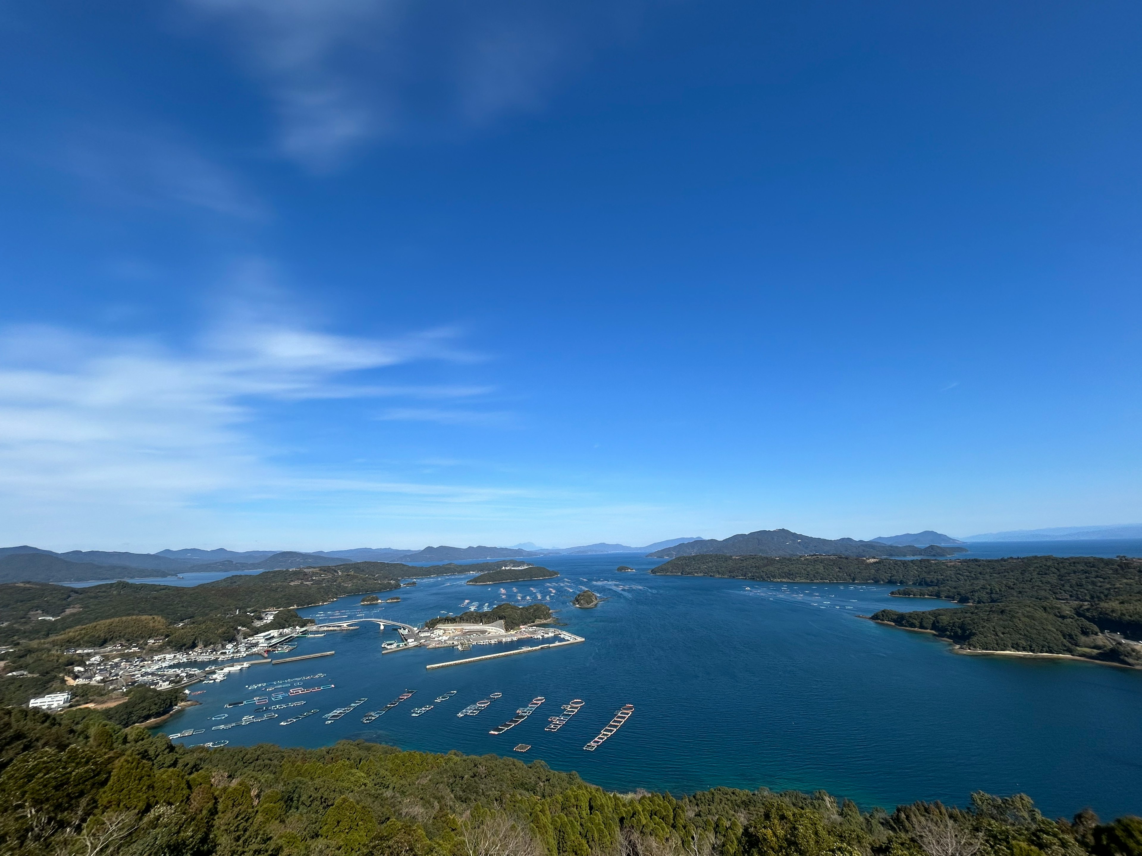 Scenic view of a harbor surrounded by blue sky and calm waters