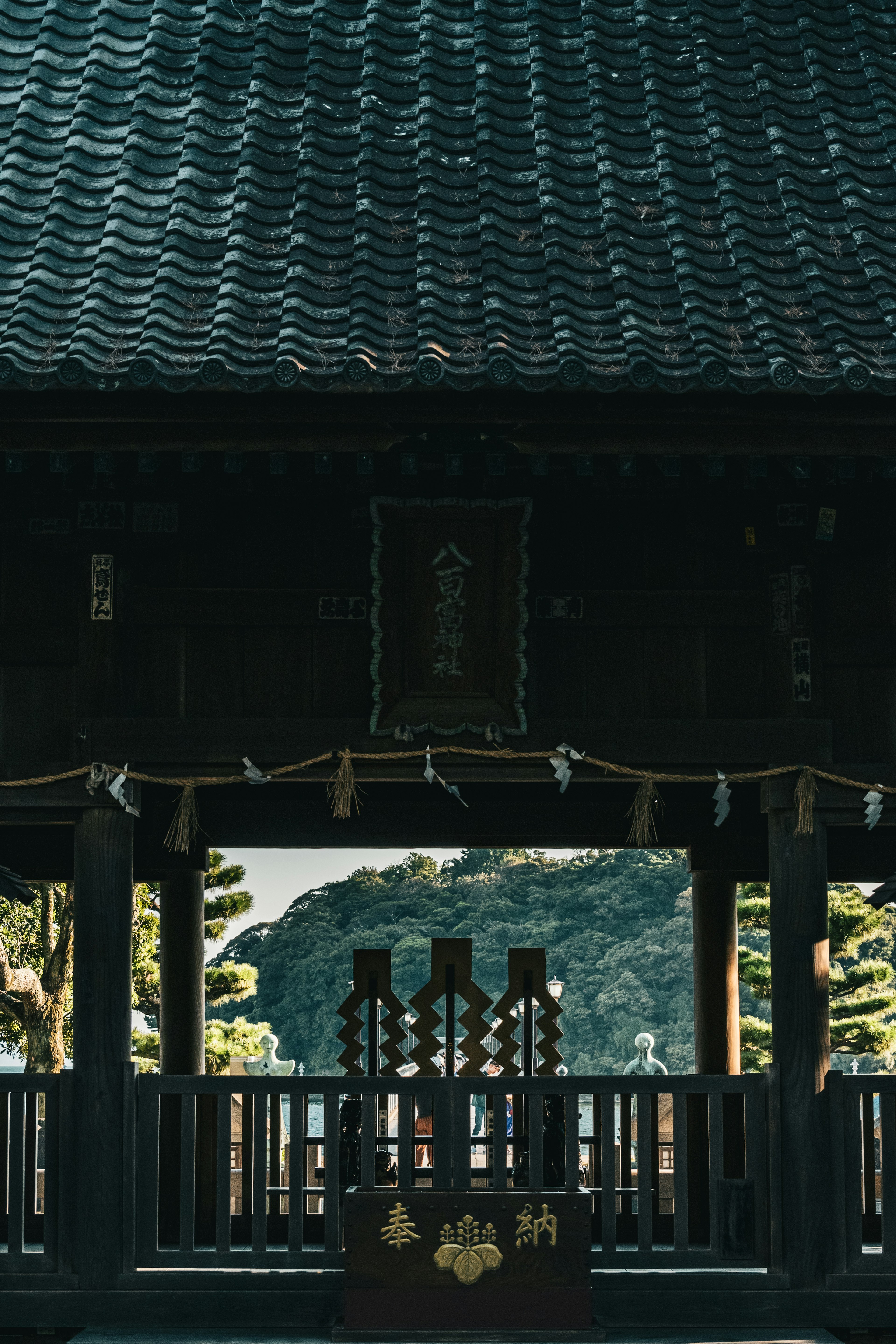 View of a traditional Japanese shrine with a decorated altar and sacred rope visible