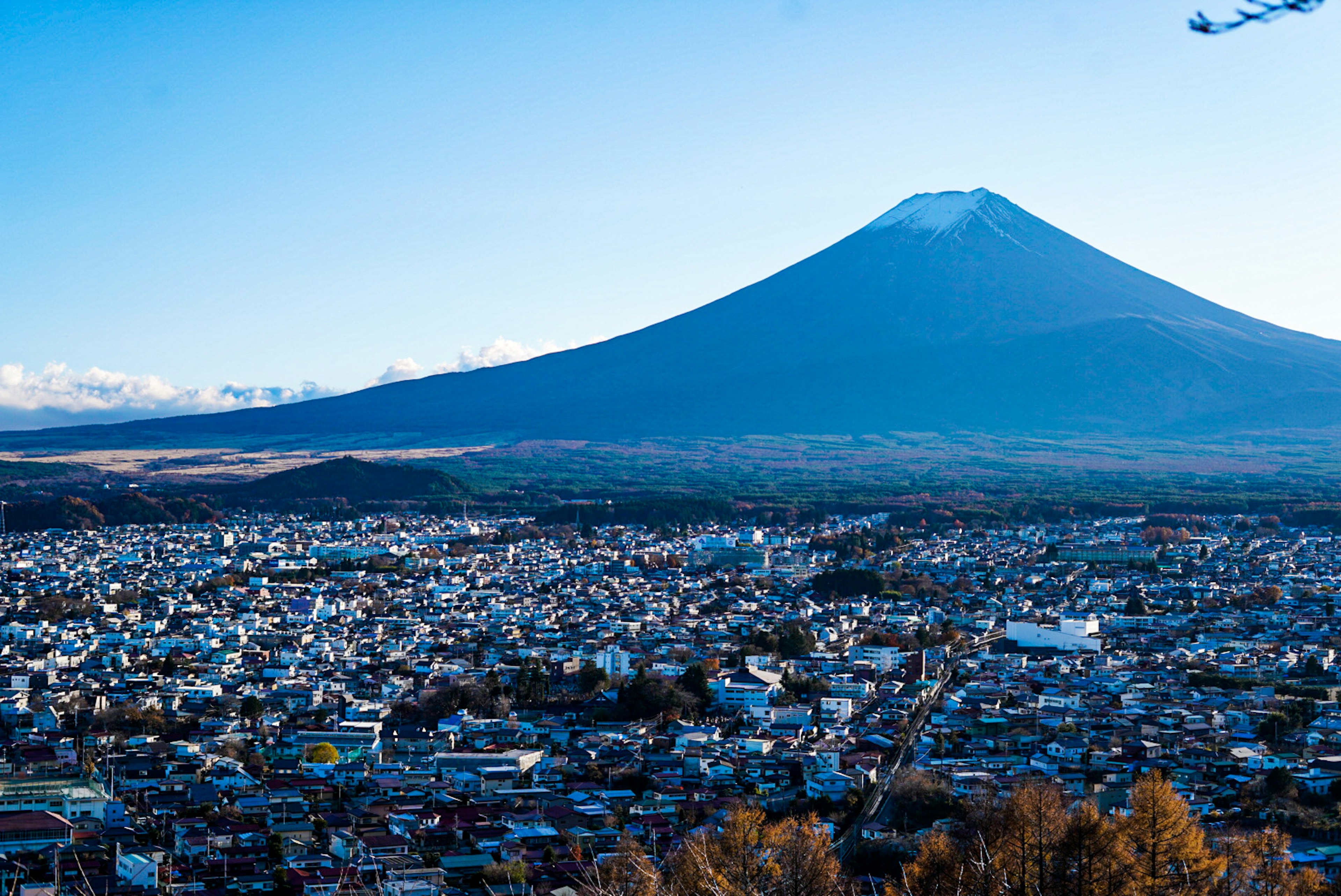 Vista del monte Fuji y la ciudad circundante bajo un cielo azul claro