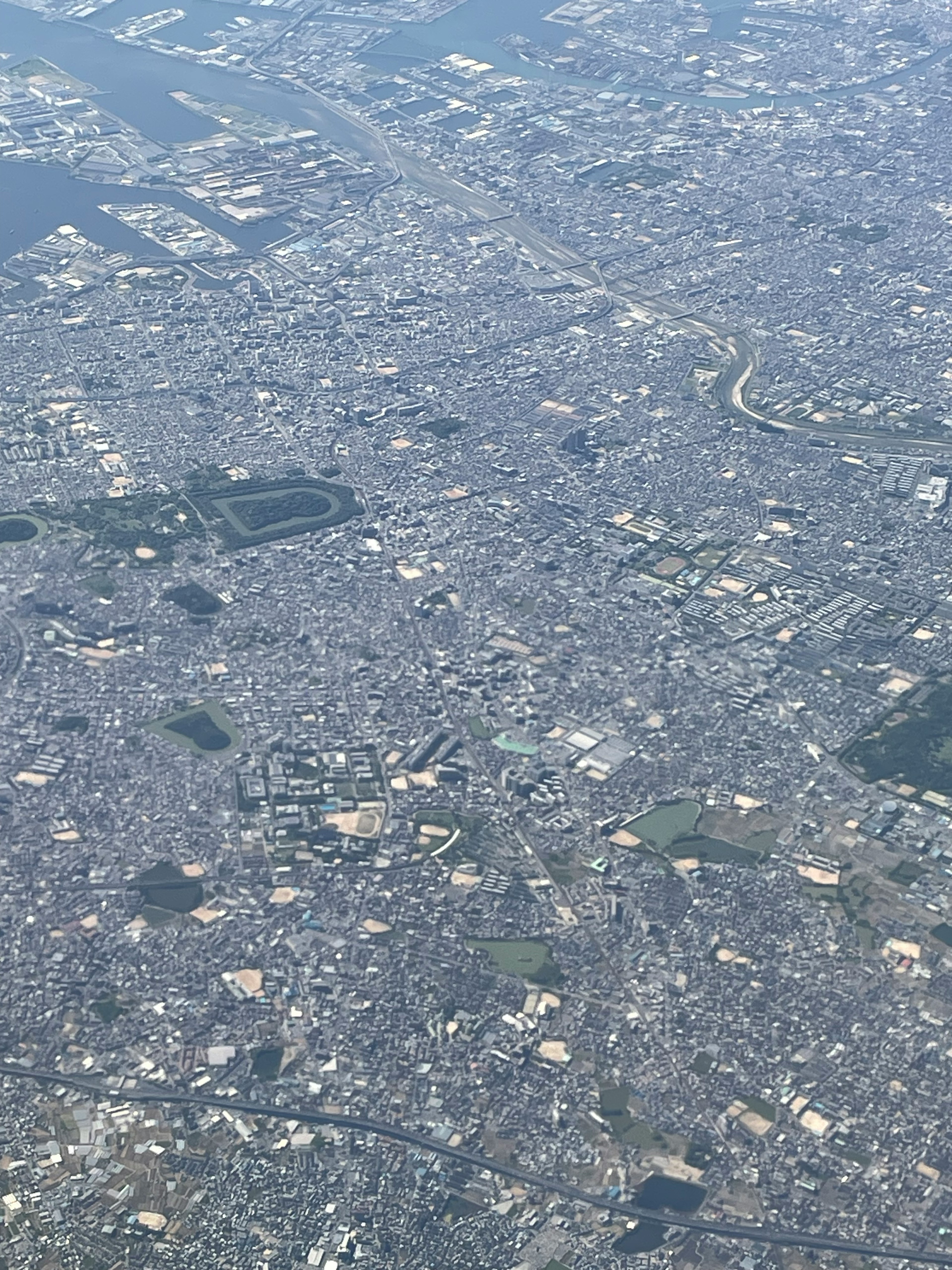 Aerial view of a sprawling urban landscape with city blocks and green spaces