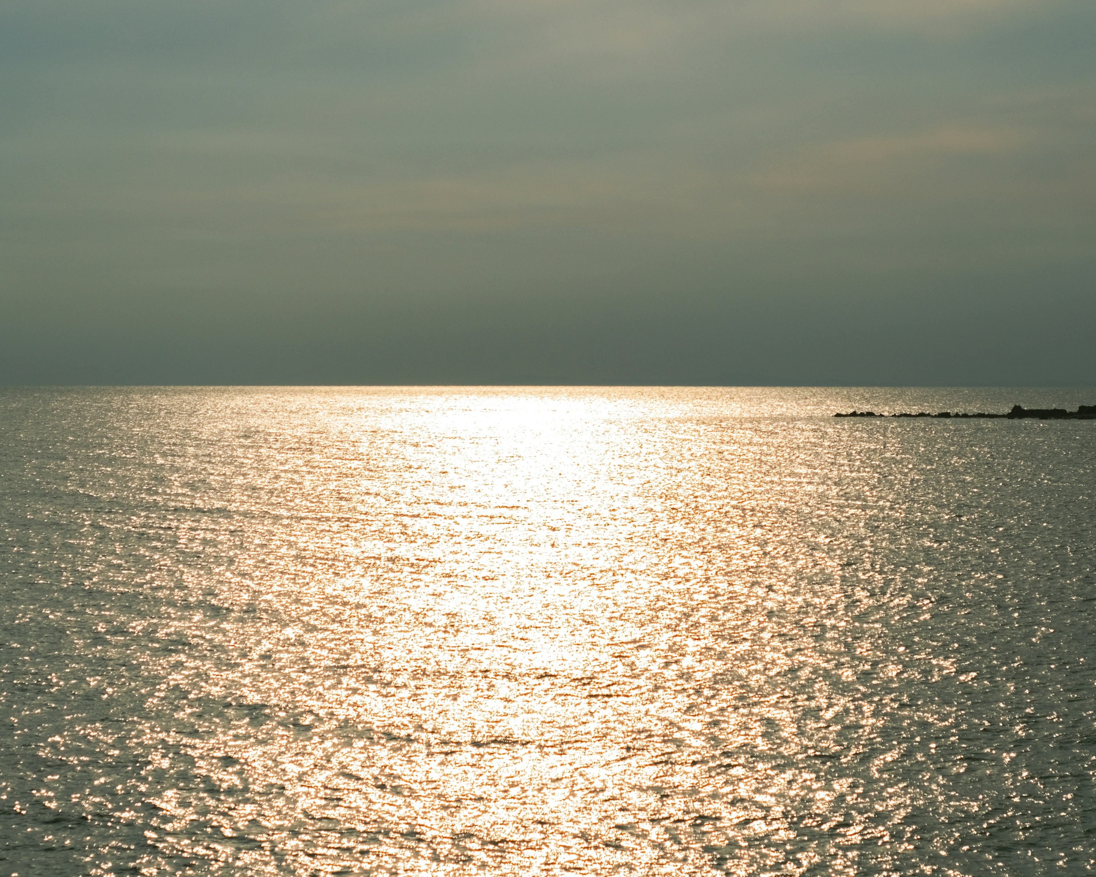 Vista di mare calma con un sentiero di luce scintillante