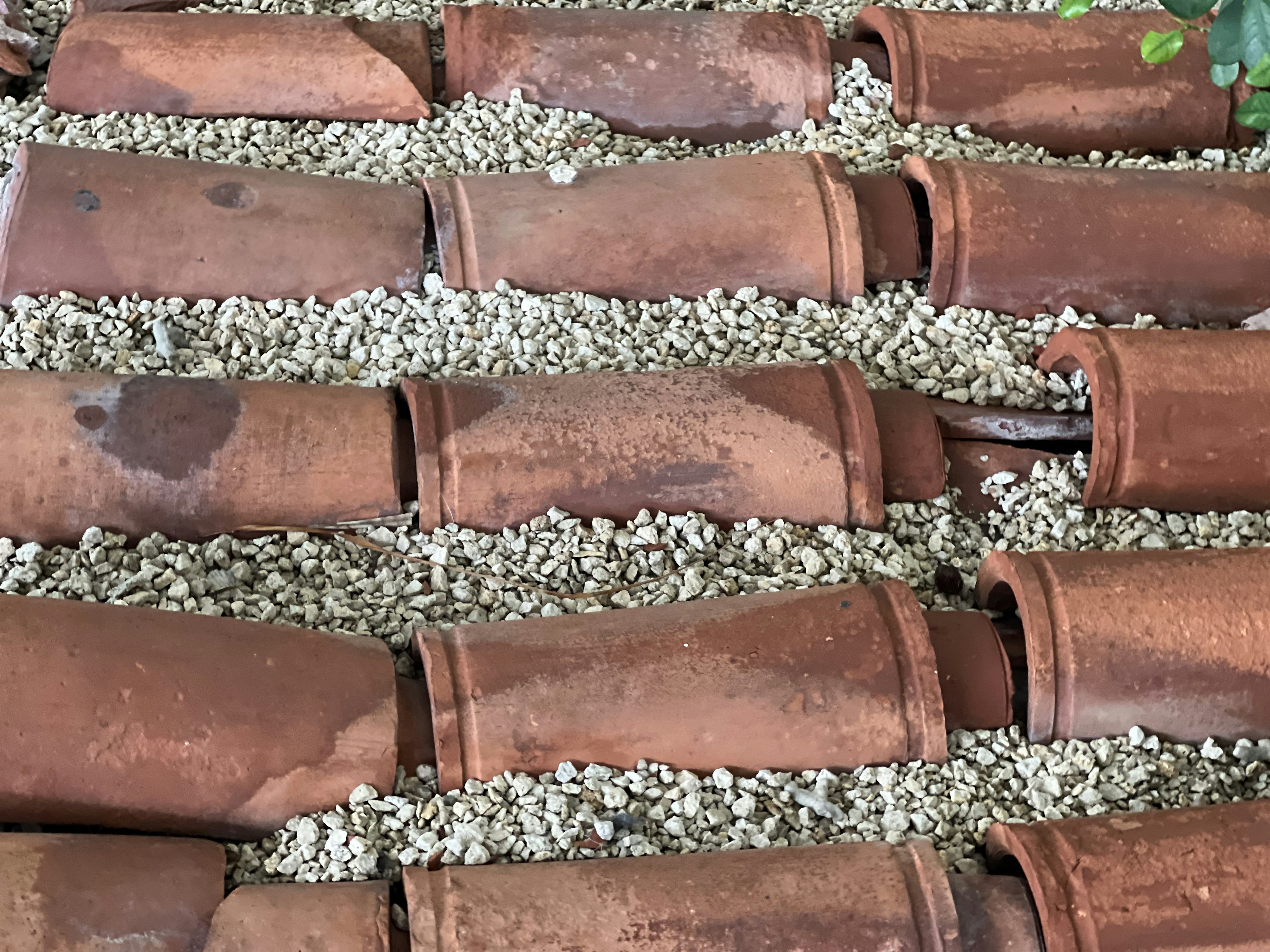 Arrangement of terracotta tiles and white gravel creating a unique landscape