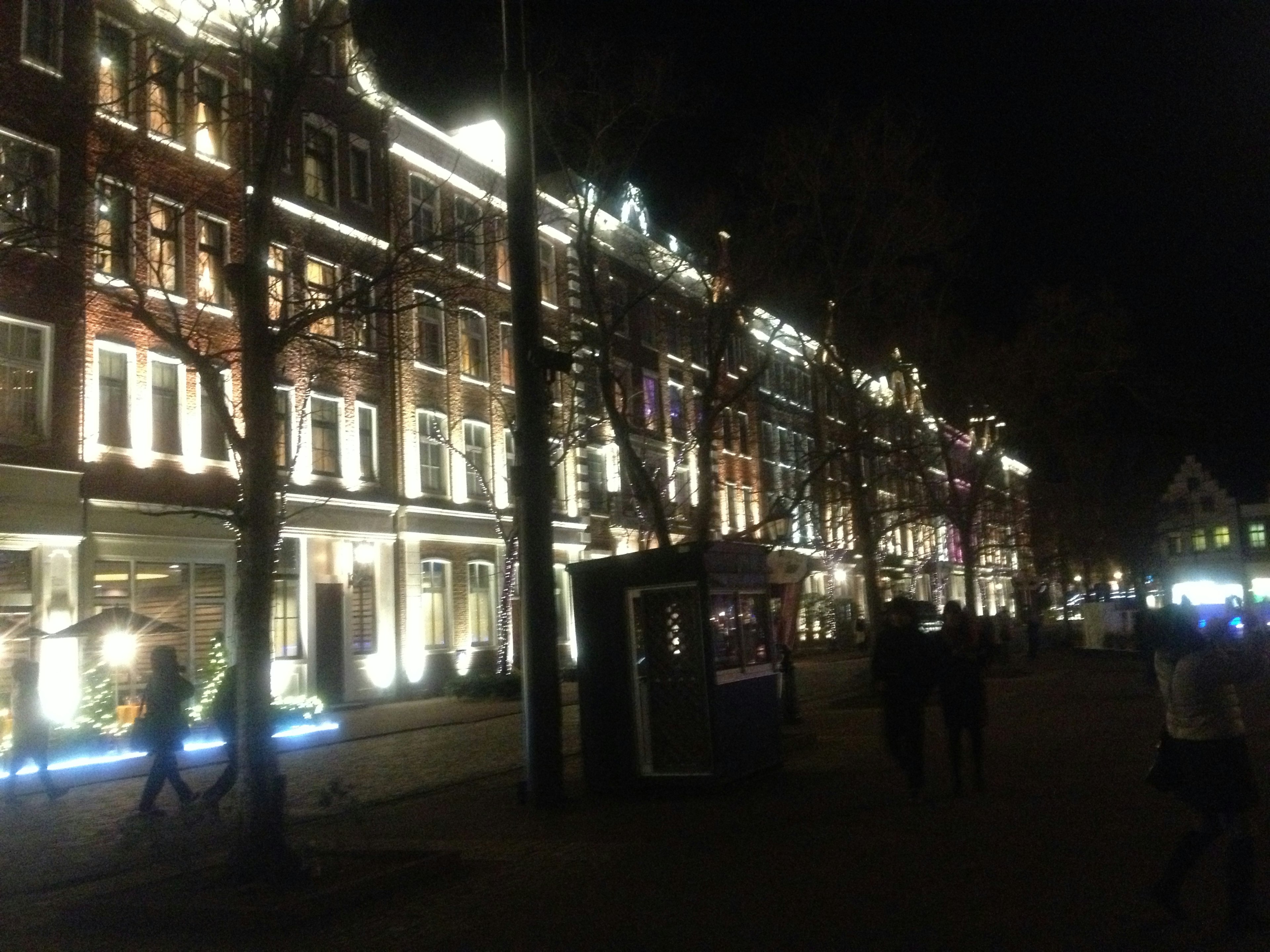 Illuminated buildings along a street at night