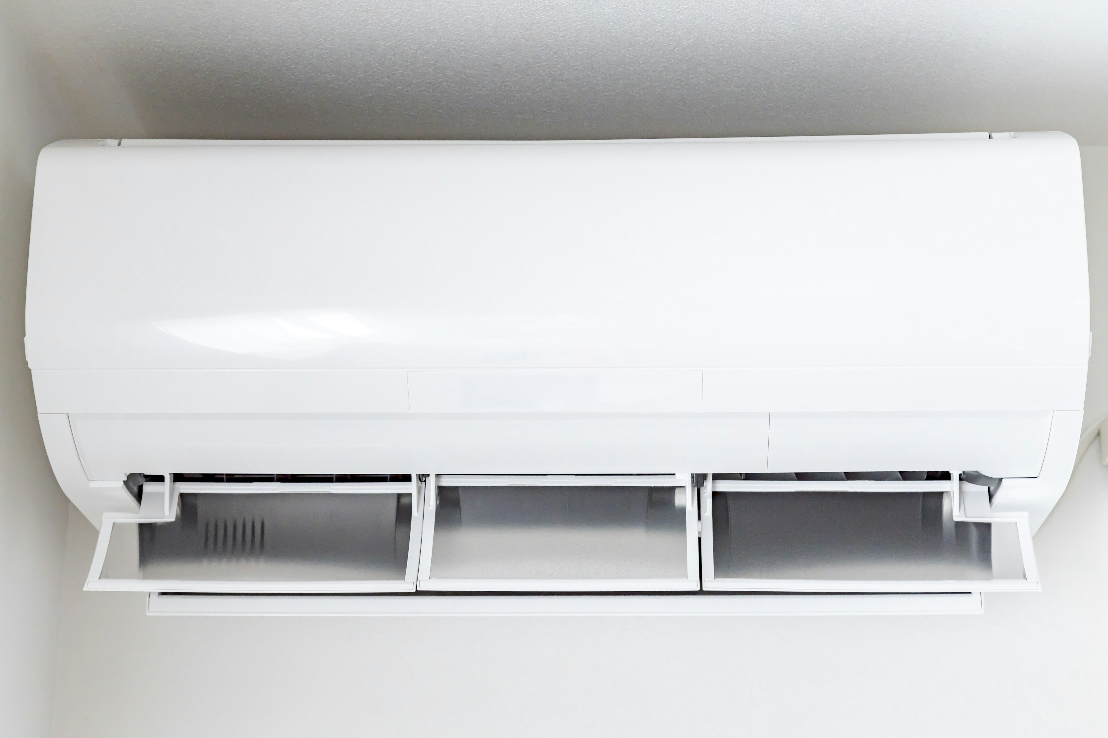 Top view of a white air conditioner with three vents