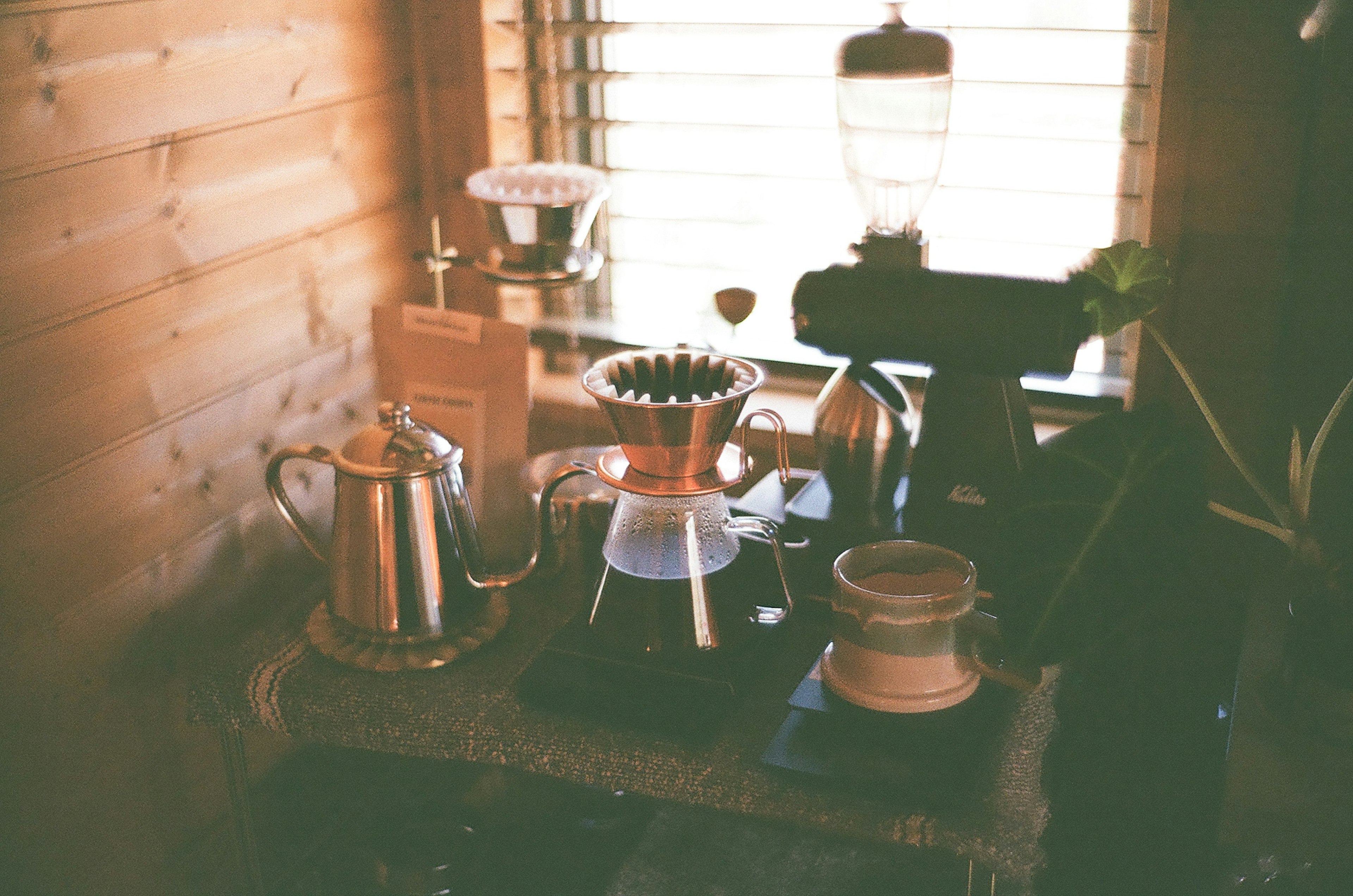 Coffee brewing setup in a cozy wooden café