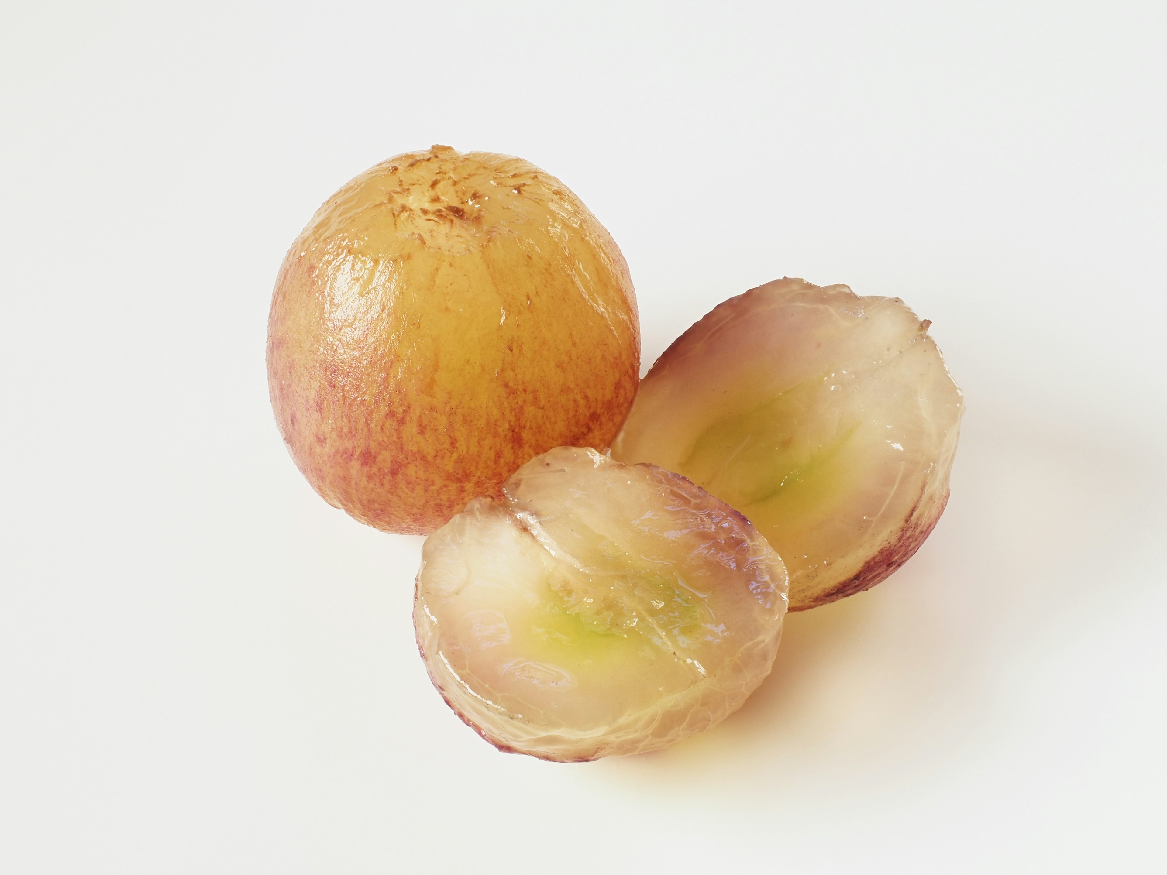 Three light-skinned onions with one cut in half